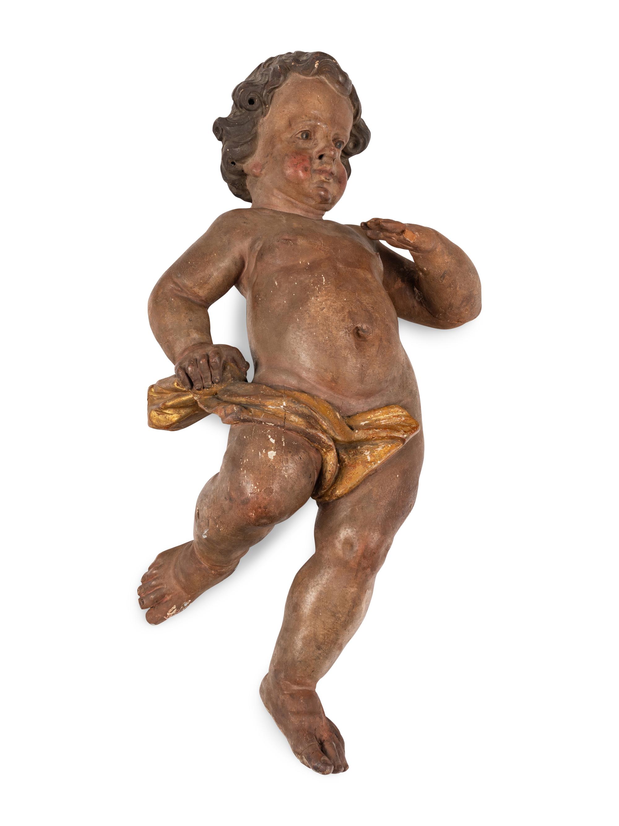 A Painted and Parcel Gilt Wood Figure of a Putto