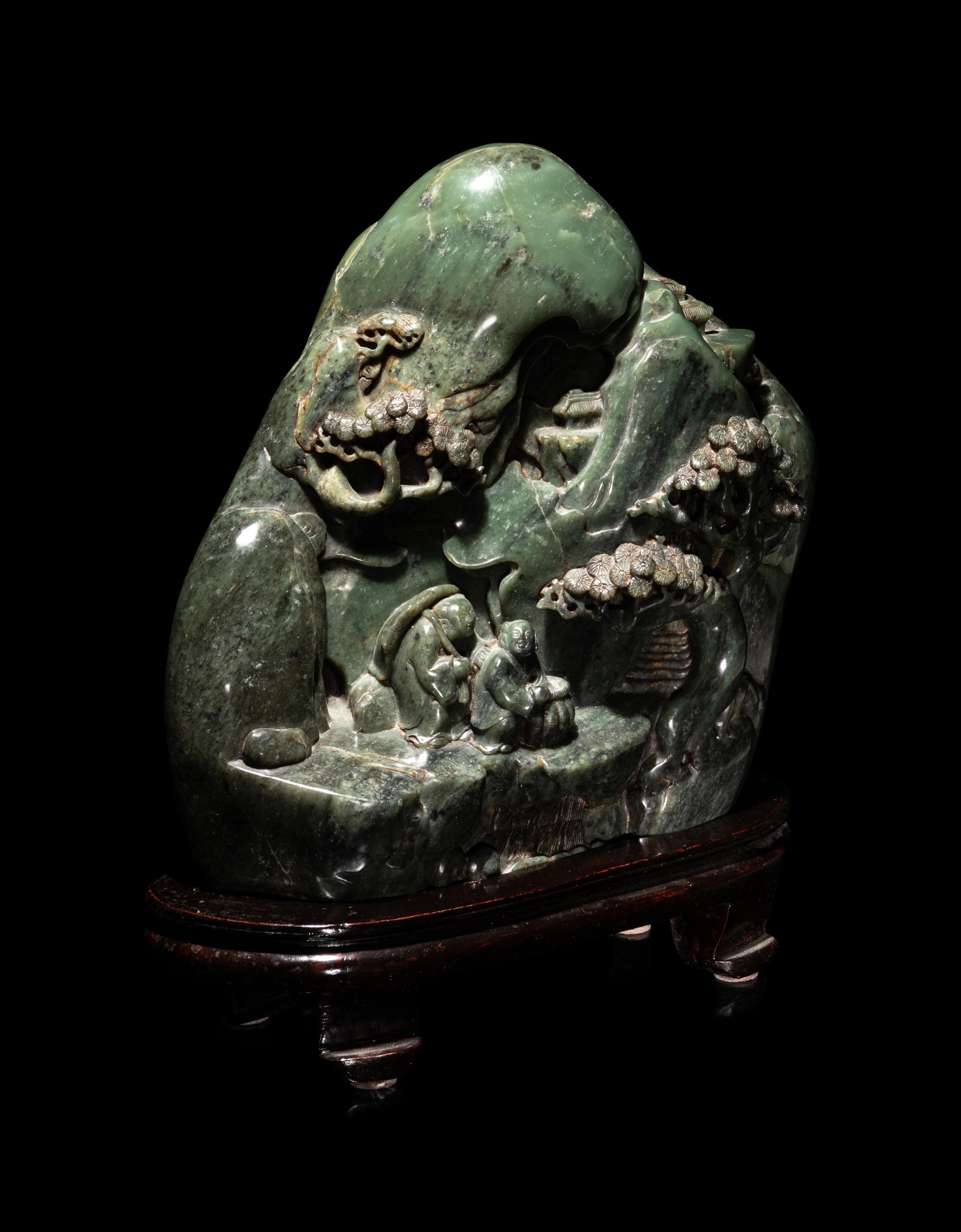 A Chinese Carved Spinach Jade 'Landscape' Boulder