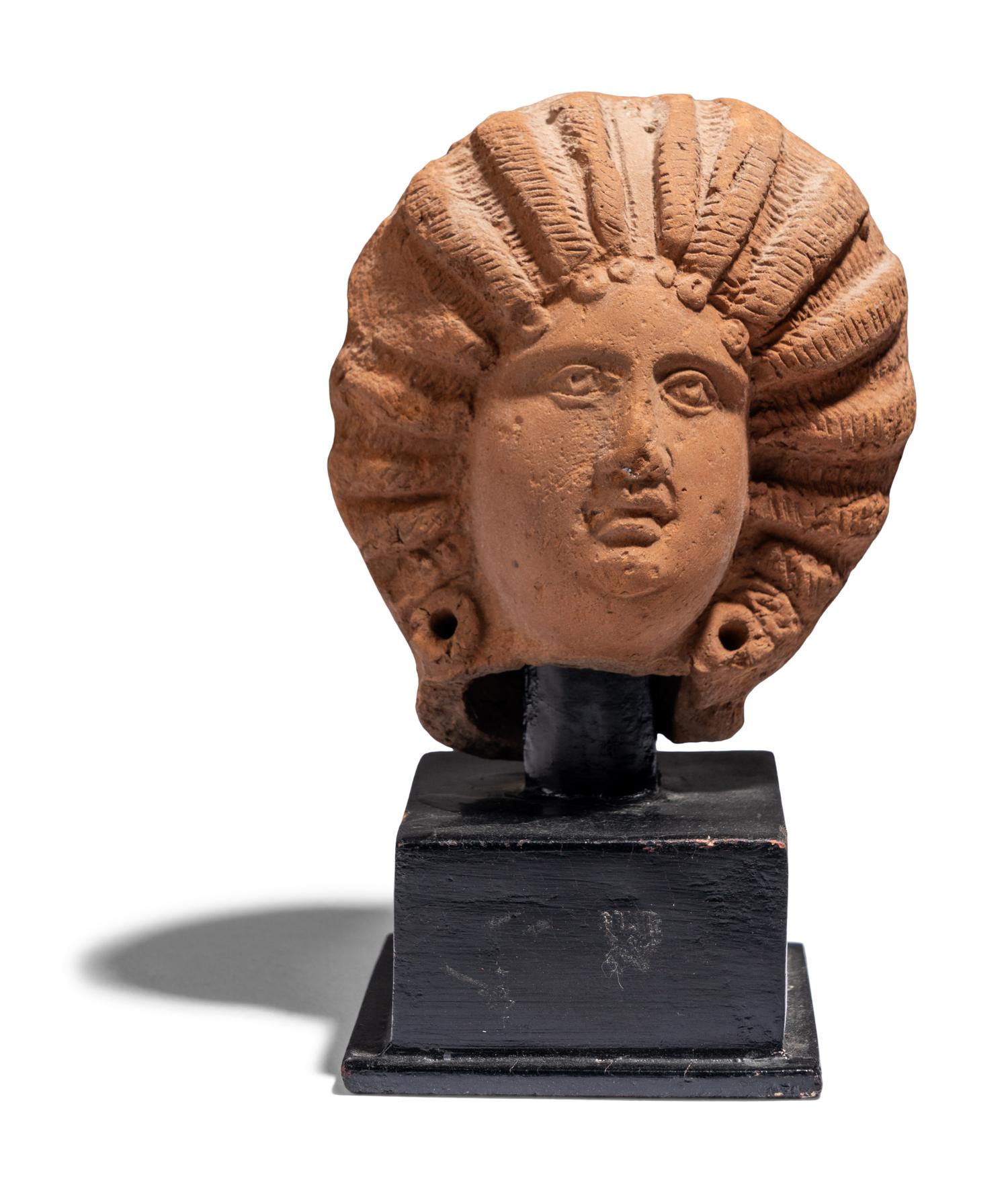 A Roman Terracotta Head of a Female with Melon Coiffure