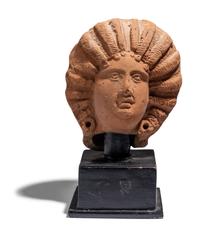A Roman Terracotta Head of a Female with Melon Coiffure