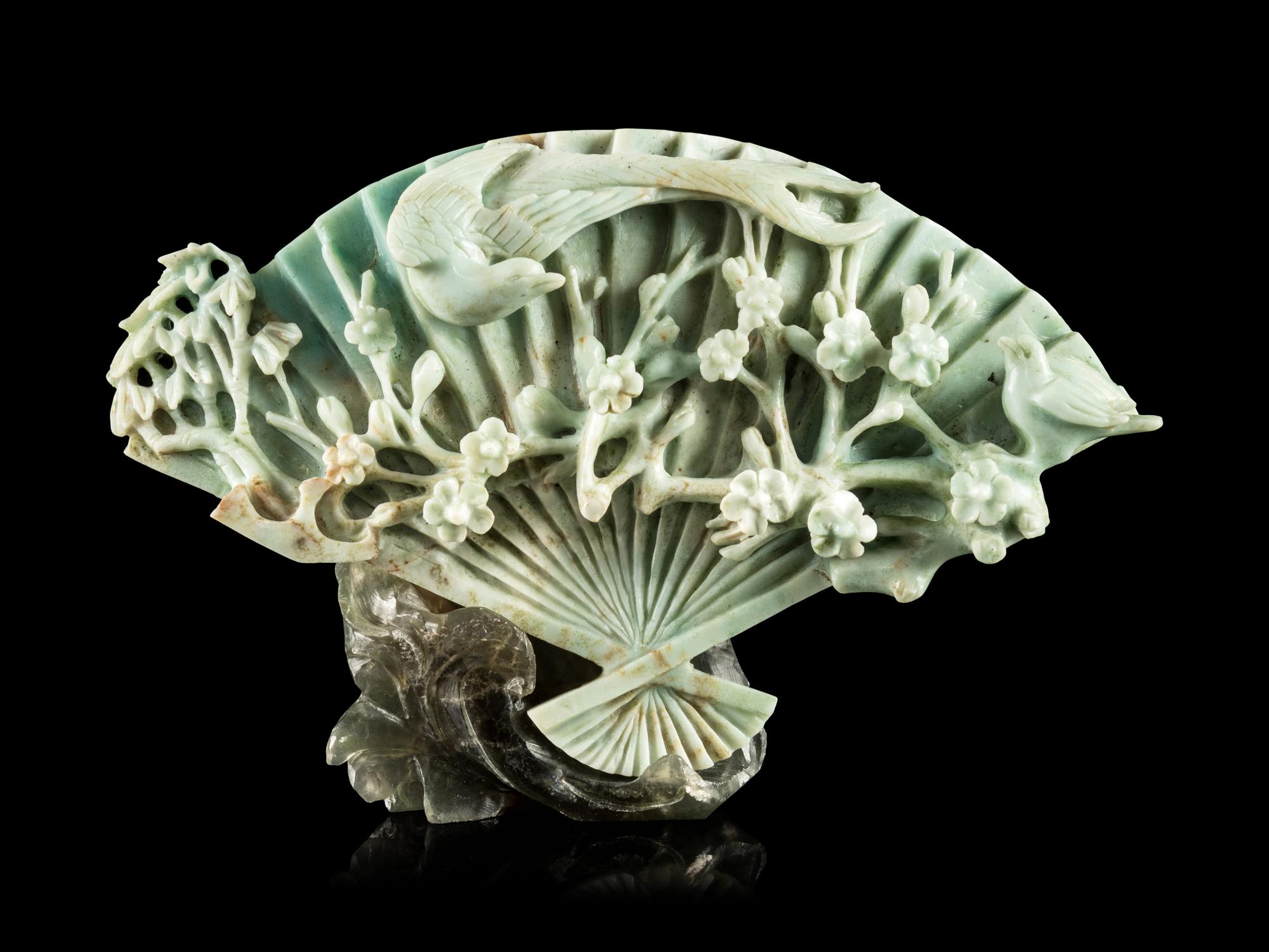 A Chinese Apple Green and Celadon Jadeite Fan-Form Carving