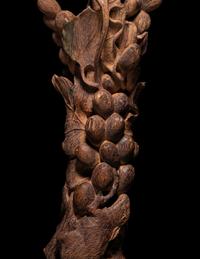 A Chinese Chenxiang Wood 'Squirrel and Grapes' Carving