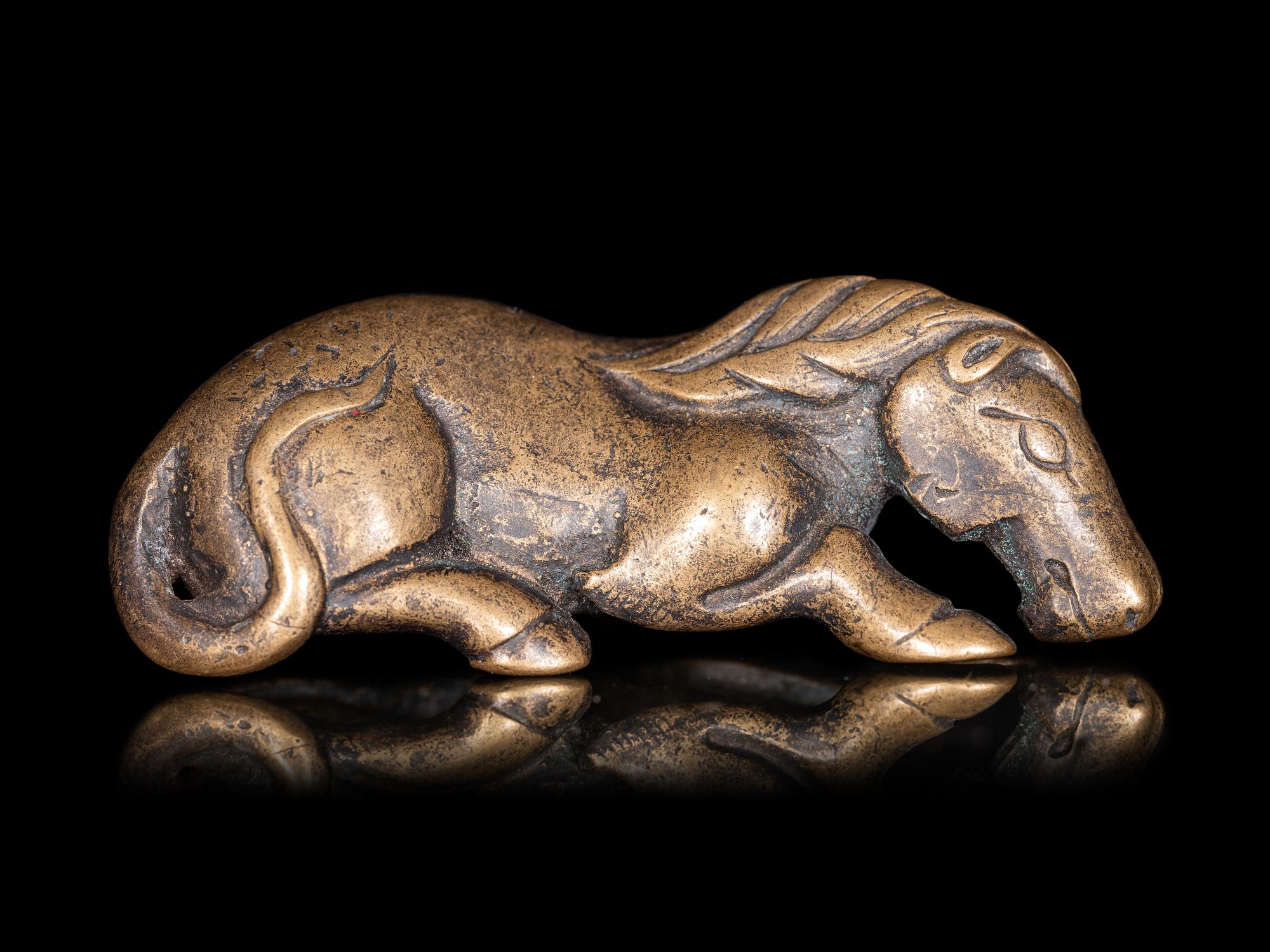 A Chinese Gilt Bronze Figure of a Recumbent Horse