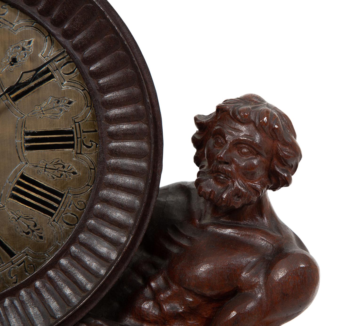 A Continental Carved Oak Figural Clock