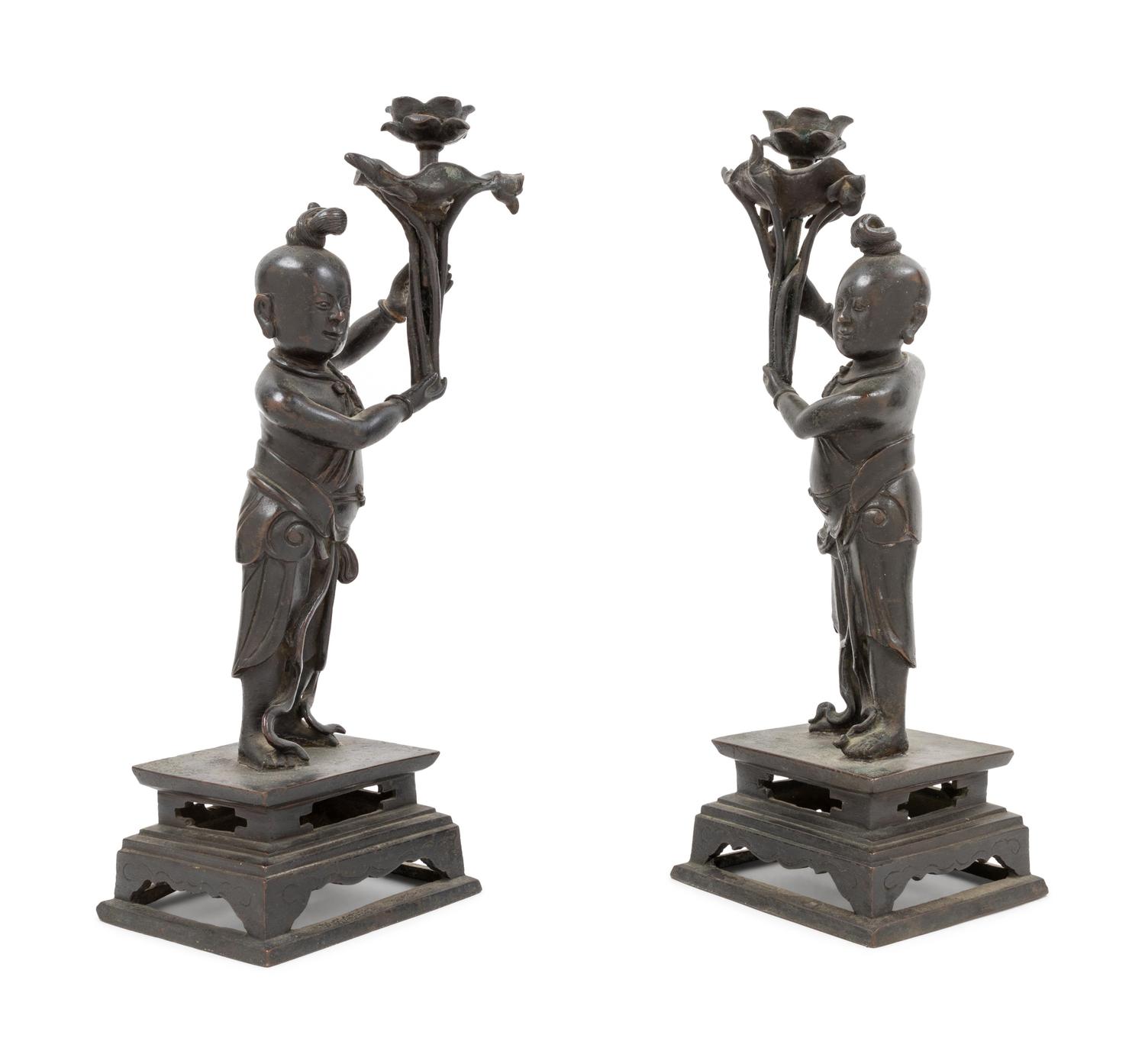 A Pair of Bronze 'Boy' Candle Holders