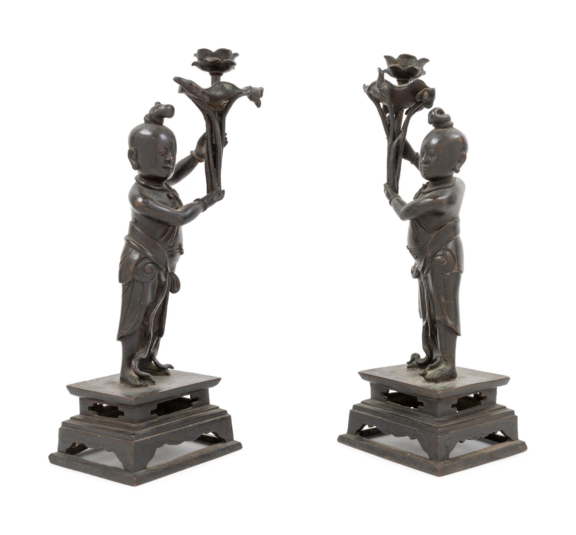 A Pair of Bronze 'Boy' Candle Holders
