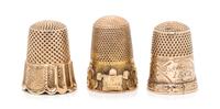 Three Yellow Gold Thimbles, , each having a knurled top and body, one example with a trefoil decorated band to the base, one example en