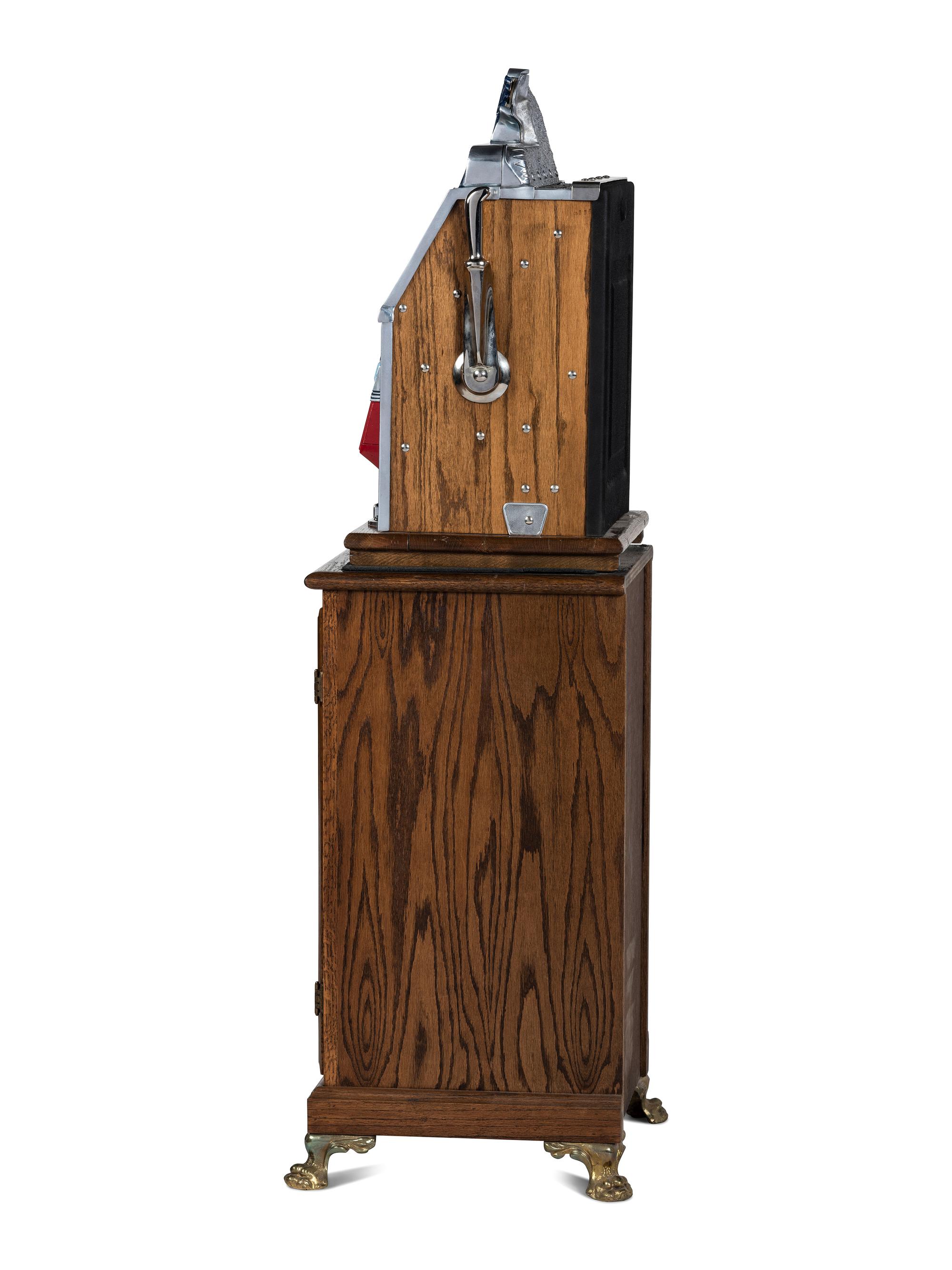 A Mills Novelty Co. Castle Front 50 Cent Slot Machine on Chief's Head Engraved Glass Stand