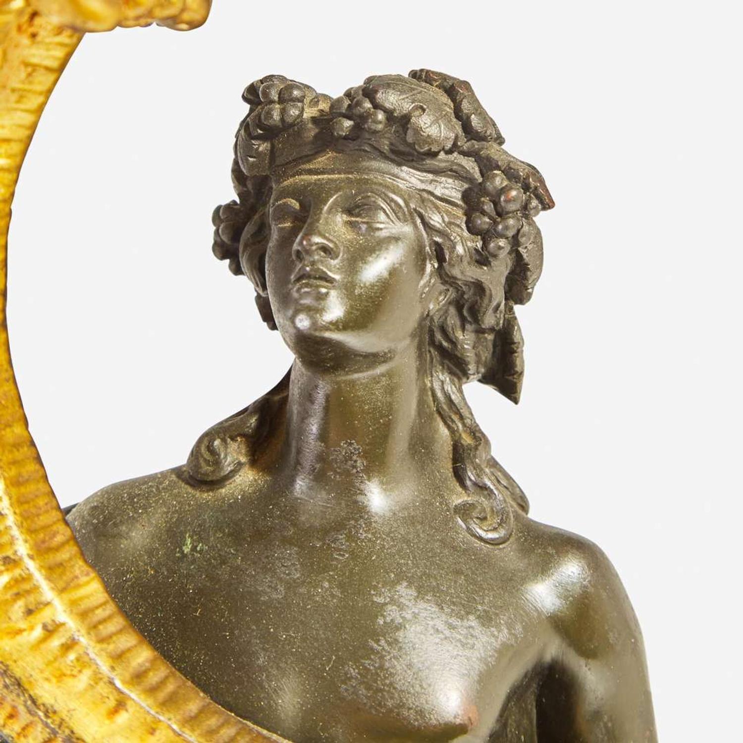 A pair of Napoleon III patinated and gilt bronze four-light figural candelabra late 19th century