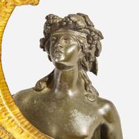 A pair of Napoleon III patinated and gilt bronze four-light figural candelabra late 19th century