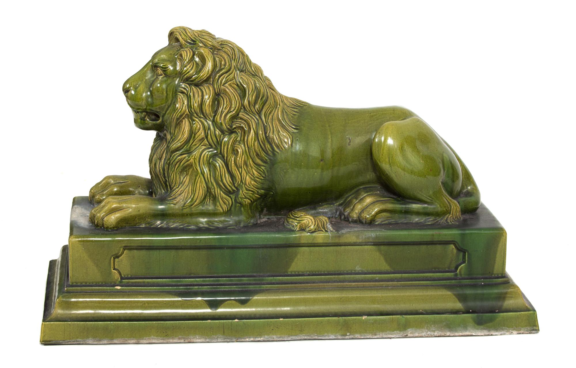 A Green Glazed Ceramic Recumbent Lion Height 23 x width 16 x depth 36 inches. — 20TH CENTURY