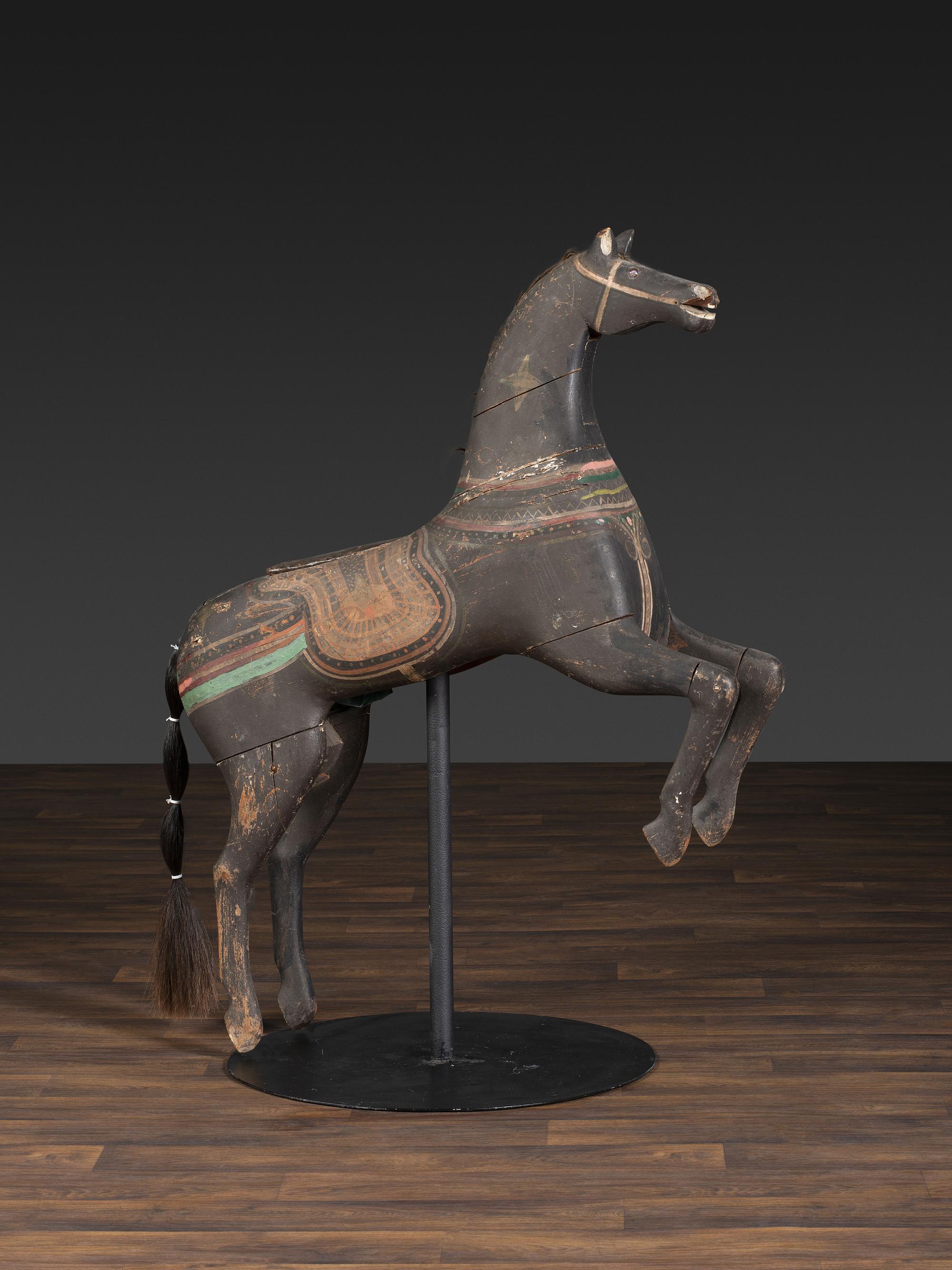 An American Glass Inset, Carved and Painted Pine Carousel Horse