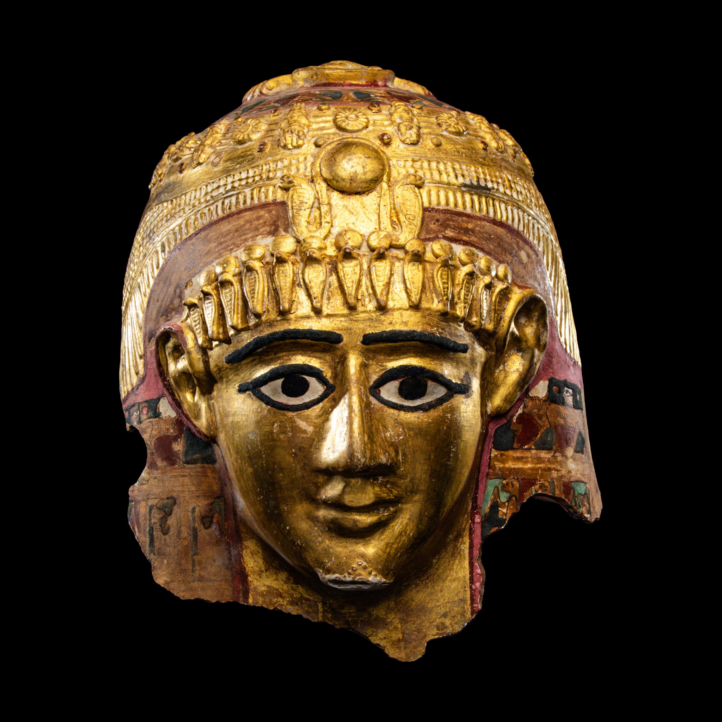An Egyptian Gilt Cartonnage Mummy Mask of a Woman