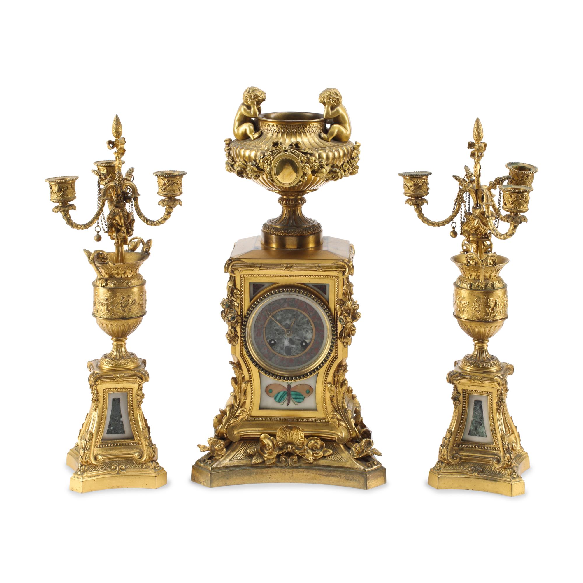 A French Gilt Bronze and Specimen Marble Three-Piece Clock Garniture