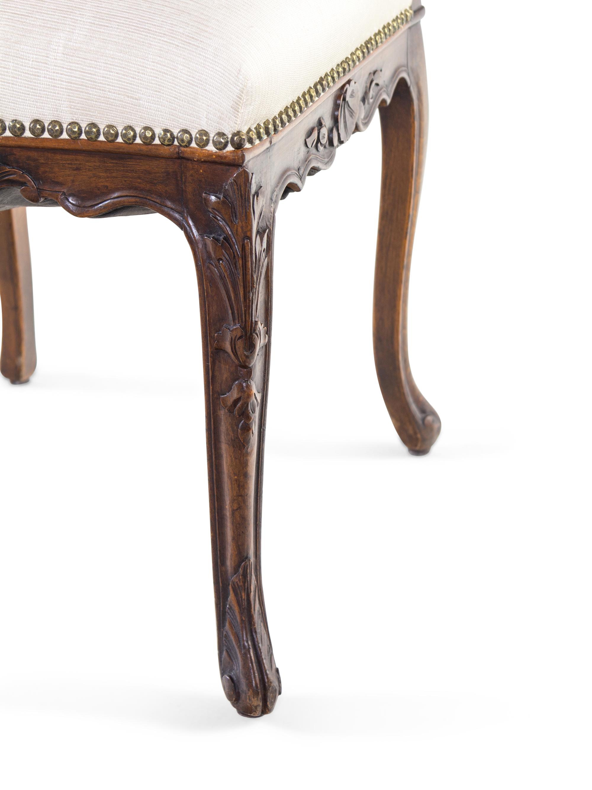 A Pair of Louis XV Style Carved Walnut Side Chairs