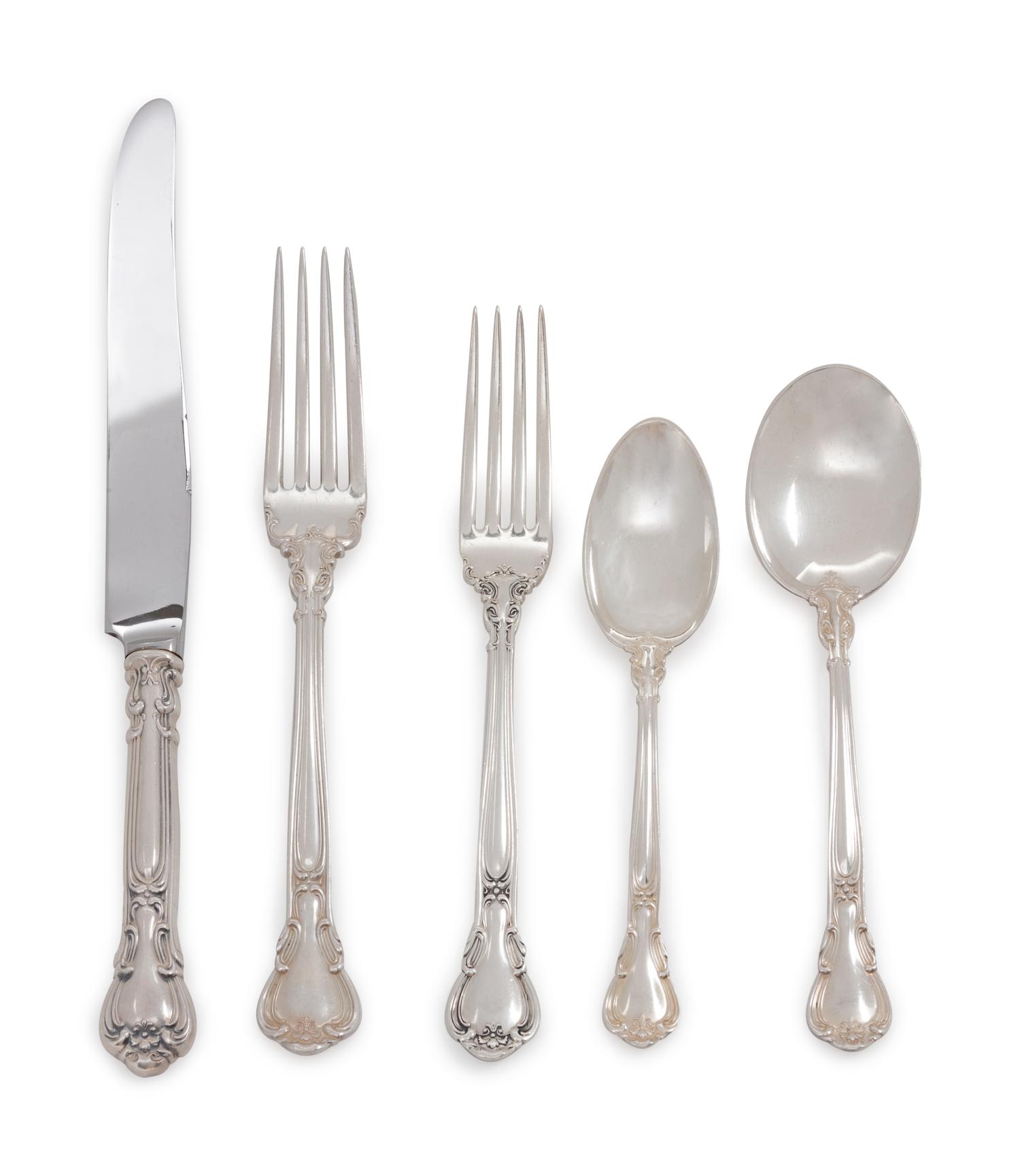 Chantilly pattern, comprising: 8 dinner knives with stainless steel blades 12 luncheon knives with stainless steel blades 12 dinner forks 12 luncheon forks 13 salad forks 20 teaspoons 12 soup cream spoons 12 small soup cream spoons 12 bouillon spoons 12 dessert spoons 12 fish knives with stainless steel blades 11 butter spreaders with stainless steel blades 12 cocktail forks 12 iced tea spoons 15 serving utensils 187 items total.