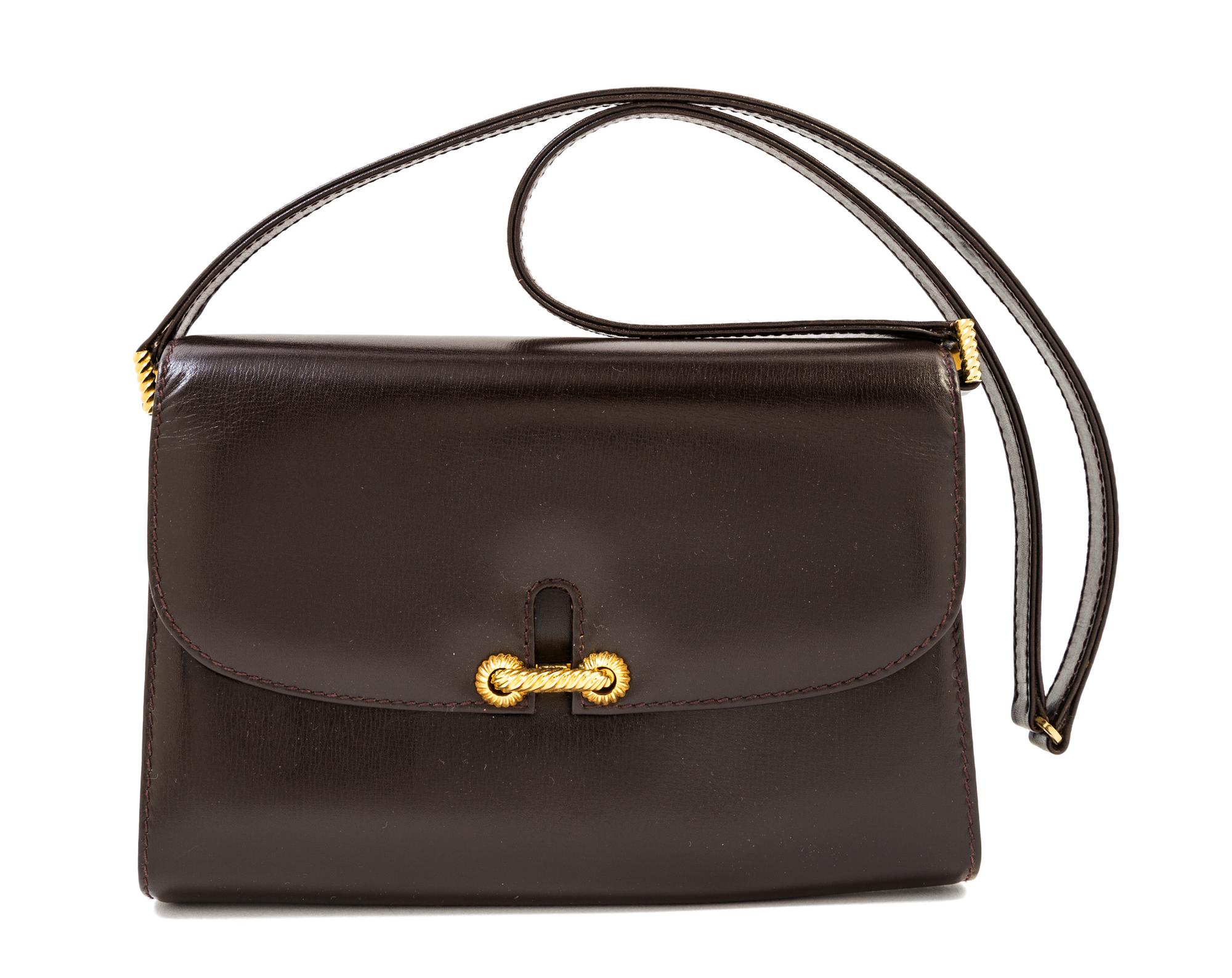 A Gucci Dark Brown Leather Flap Handbag, 8" x 6" x 2"; Strap drop: 14".