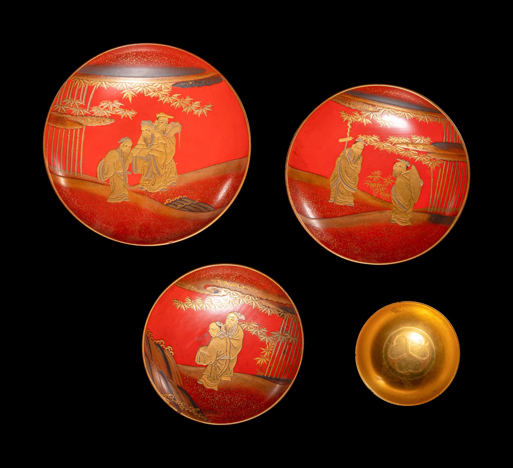 A Set of Three Japanese Gilt Decorated Red Lacquered Stem Dishes