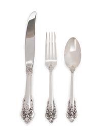 Grand Baroque pattern, comprising: 11 dinner knives with stainless steel blades 8 steak knives with stainless steel blades 16 luncheon knives with stainless steel blades 14 butter spreaders with stainless steel blades 10 butter spreaders 8 dinner forks 28 place forks 24 luncheon forks 12 cocktail forks 12 salad forks 12 soup spoons 25 teaspoons 9 dessert spoons 5 grapefruit spoons 10 iced tea spoons 12 demitasse spoons 2 salt spoons 13 strawberry forks 2 fish knives with stainless steel blades 2 salt spoons 26 serving utensils 5 serving utensils with stainless steel blades 266 items total.
