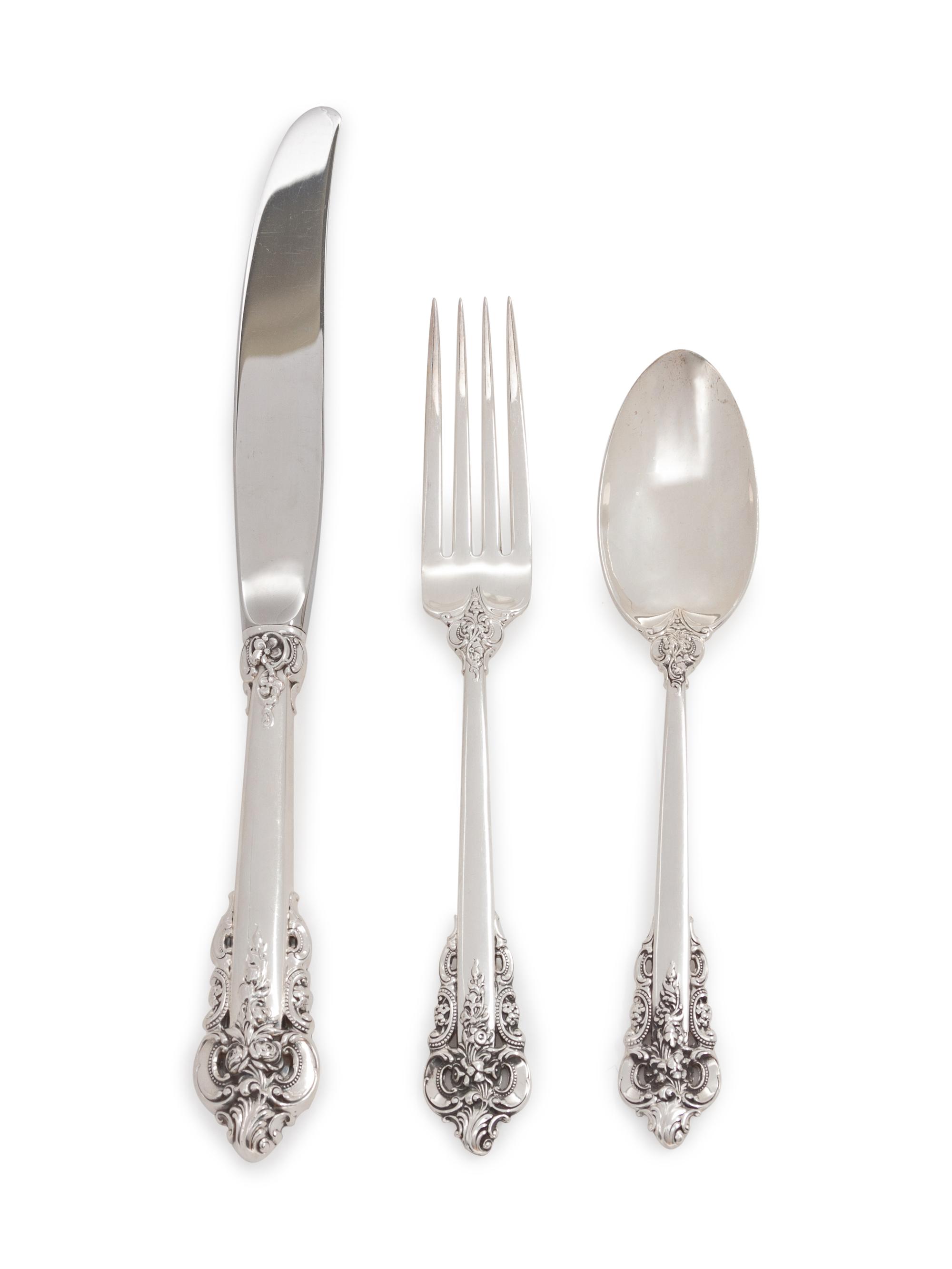 Grand Baroque pattern, comprising: 11 dinner knives with stainless steel blades 8 steak knives with stainless steel blades 16 luncheon knives with stainless steel blades 14 butter spreaders with stainless steel blades 10 butter spreaders 8 dinner forks 28 place forks 24 luncheon forks 12 cocktail forks 12 salad forks 12 soup spoons 25 teaspoons 9 dessert spoons 5 grapefruit spoons 10 iced tea spoons 12 demitasse spoons 2 salt spoons 13 strawberry forks 2 fish knives with stainless steel blades 2 salt spoons 26 serving utensils 5 serving utensils with stainless steel blades 266 items total.