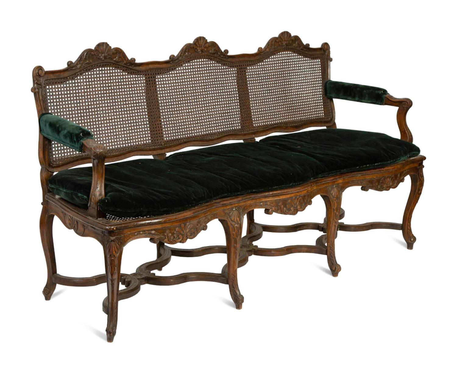 A Régence Style Carved Walnut Triple Chair-Back Settee