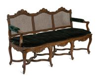 A Régence Style Carved Walnut Triple Chair-Back Settee