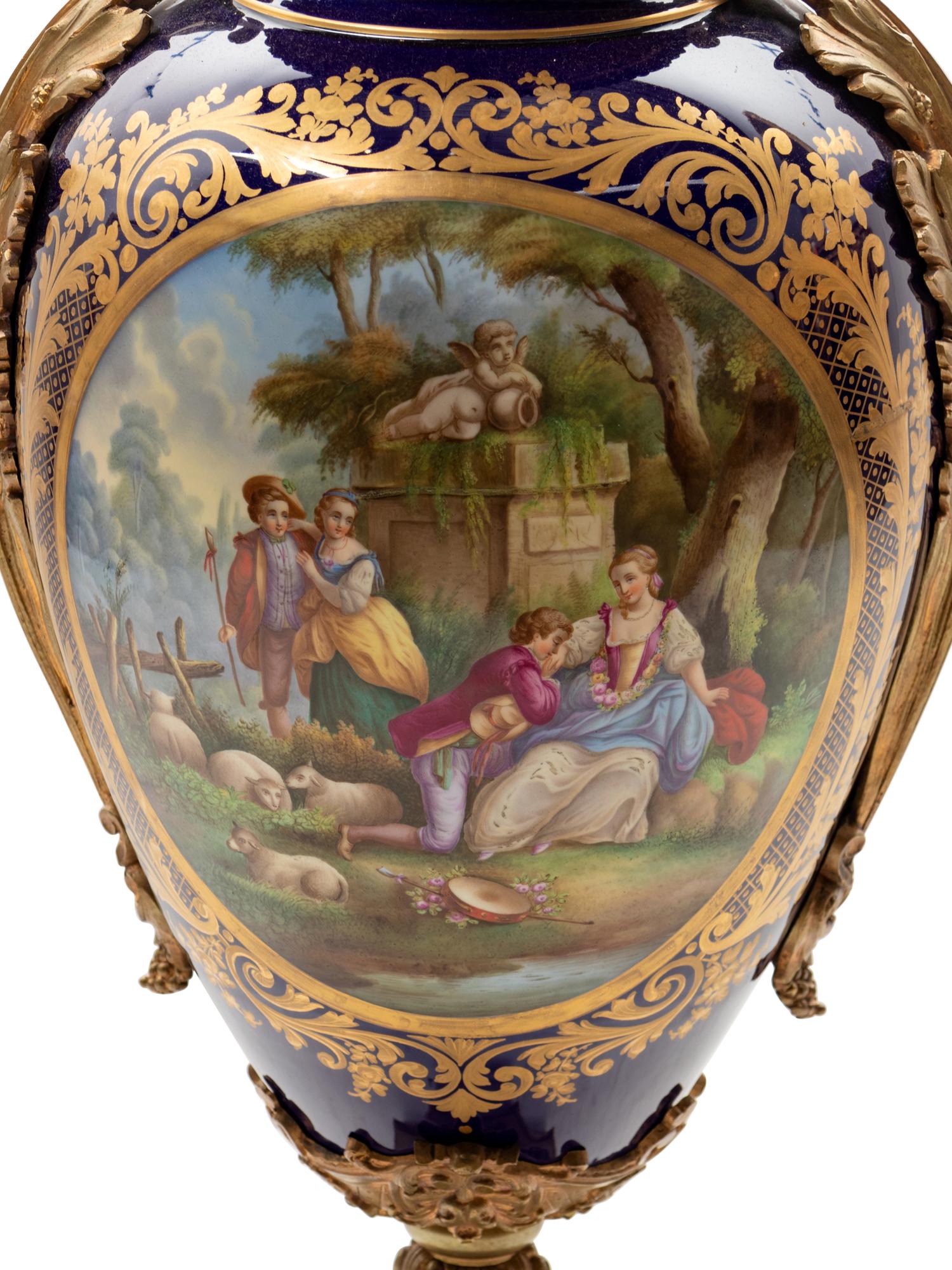 A Sèvres Style Gilt Bronze Mounted Painted and Parcel Gilt Porcelain Urn