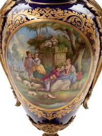 A Sèvres Style Gilt Bronze Mounted Painted and Parcel Gilt Porcelain Urn