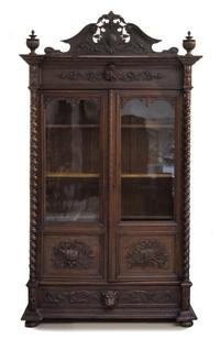 A Renaissance Revival Oak Vitrine Height 106 x width 60 x depth 22 inches. — FIRST HALF 20TH CENTURY