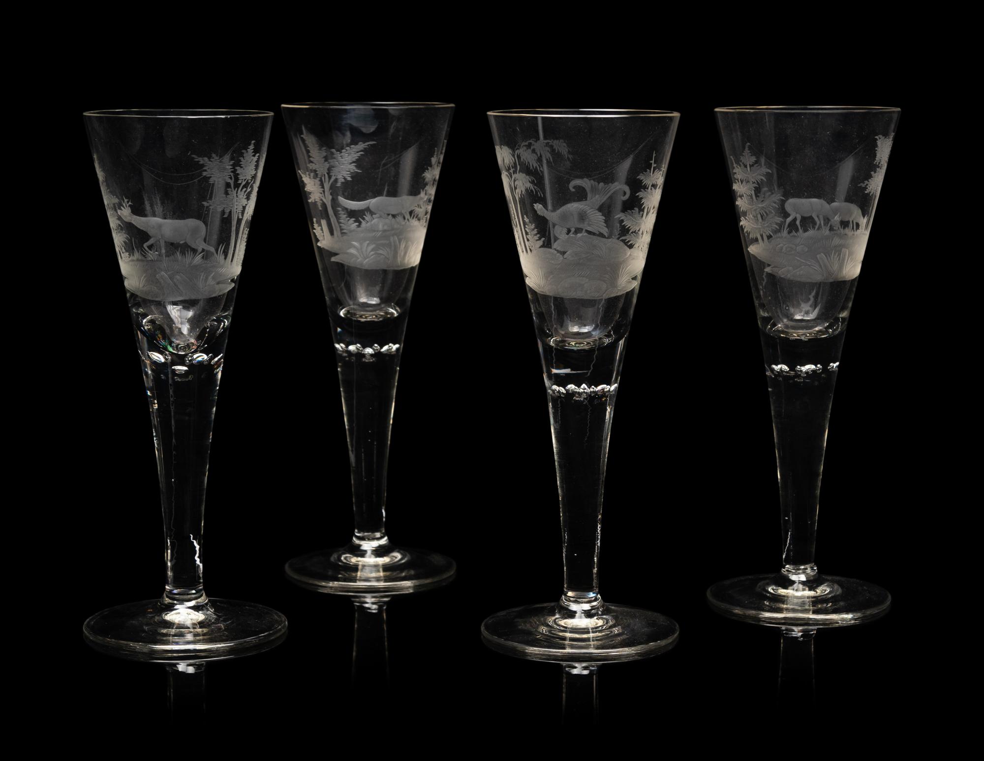 A Set of Four Large Etched Glass Wine Stems