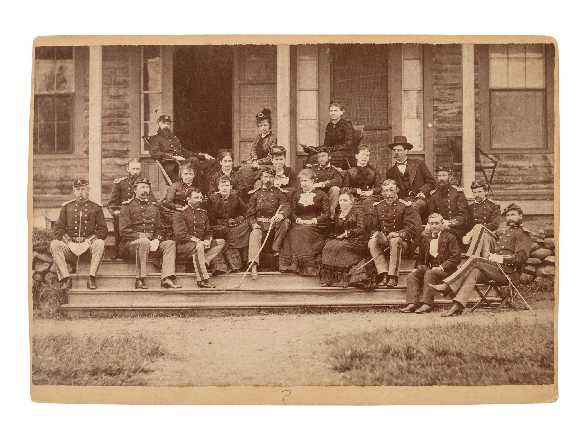 [LITTLE BIGHORN]. Cabinet card group portrait of 17th Infantry officers and their female friends relaxing just prior to setting out on the 1876 campaign.