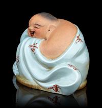 A Celadon Glazed Porcelain Figure of a Budai Buddha