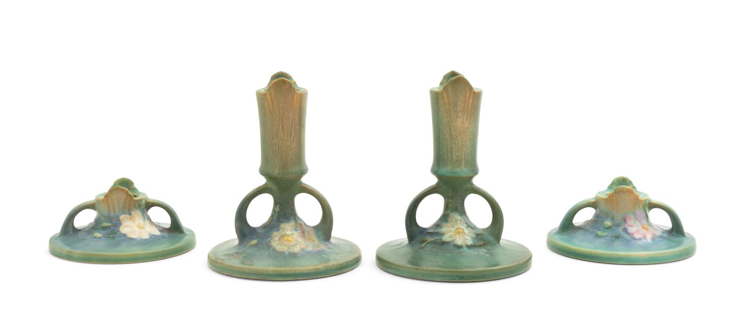 Two Pairs of Roseville Cosmos Pottery Candlesticks Height of taller pair 5 1/4 inches, shorter pair 2 inches.