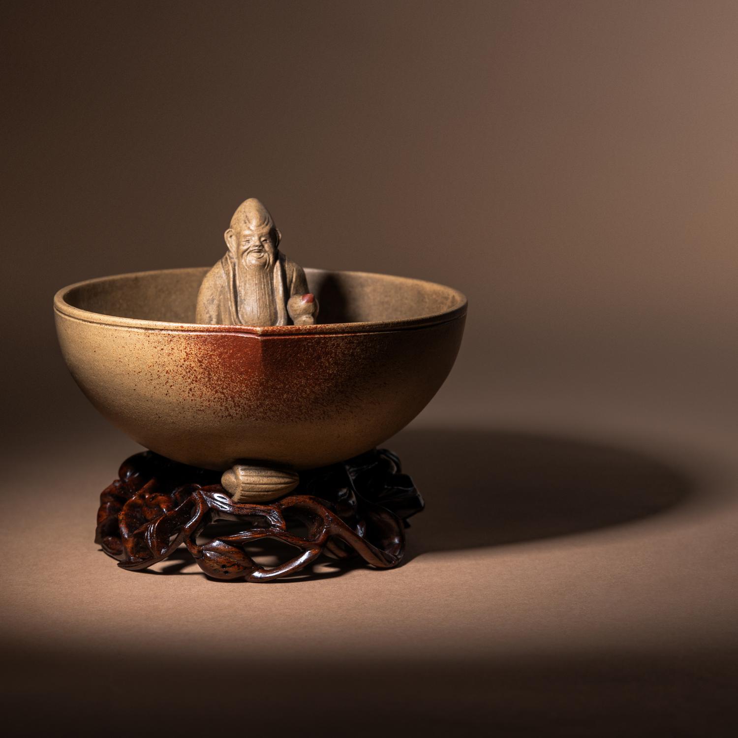 A Rare Yixing Peach-Form 'Figure' Puzzle Cup with Impressed Seals 'Chen', 'Mingyuan' and Wood Stand 陳鳴遠款醉翁桃形公道杯