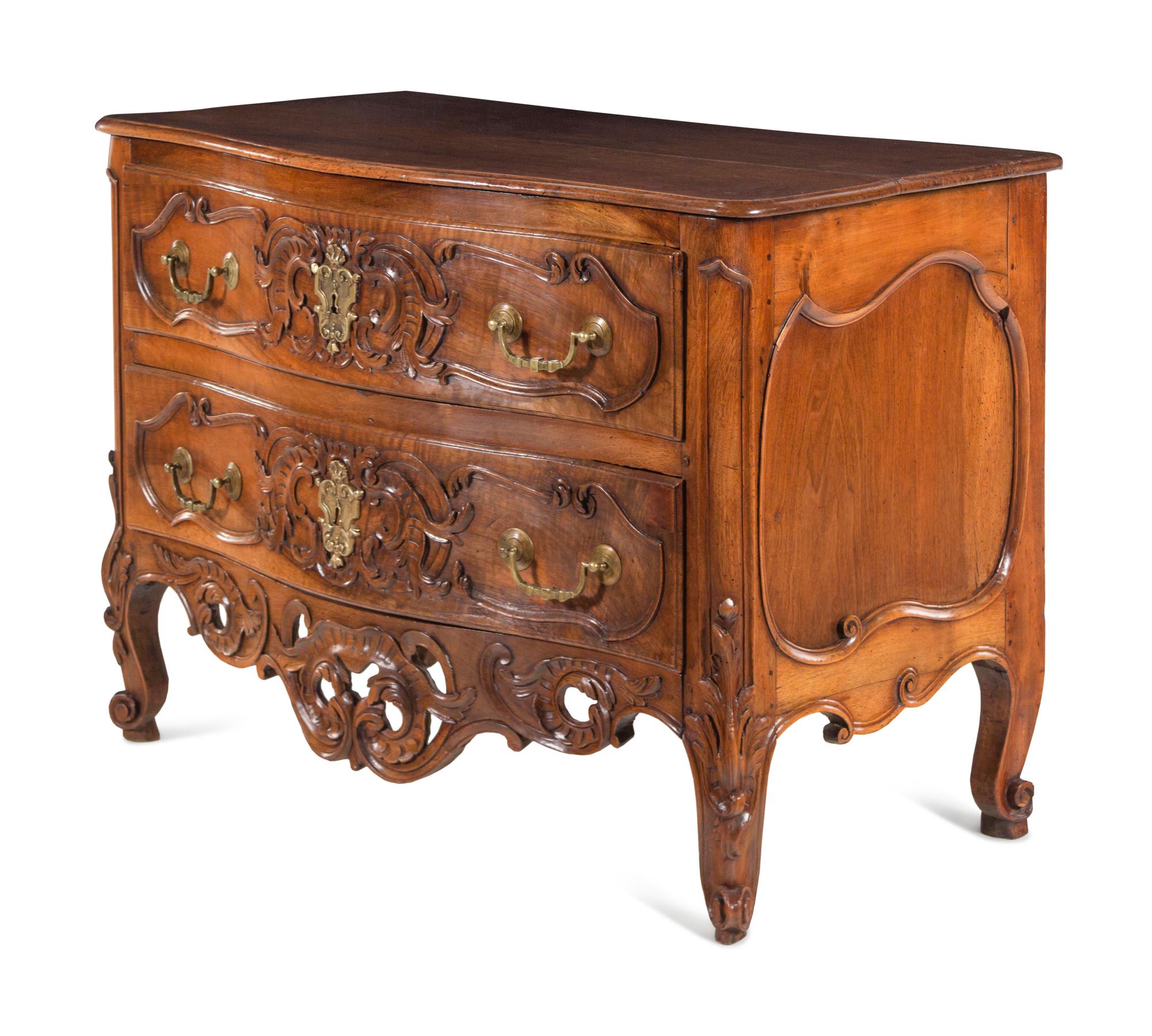 A Louis XV Provincial Carved Walnut Commode