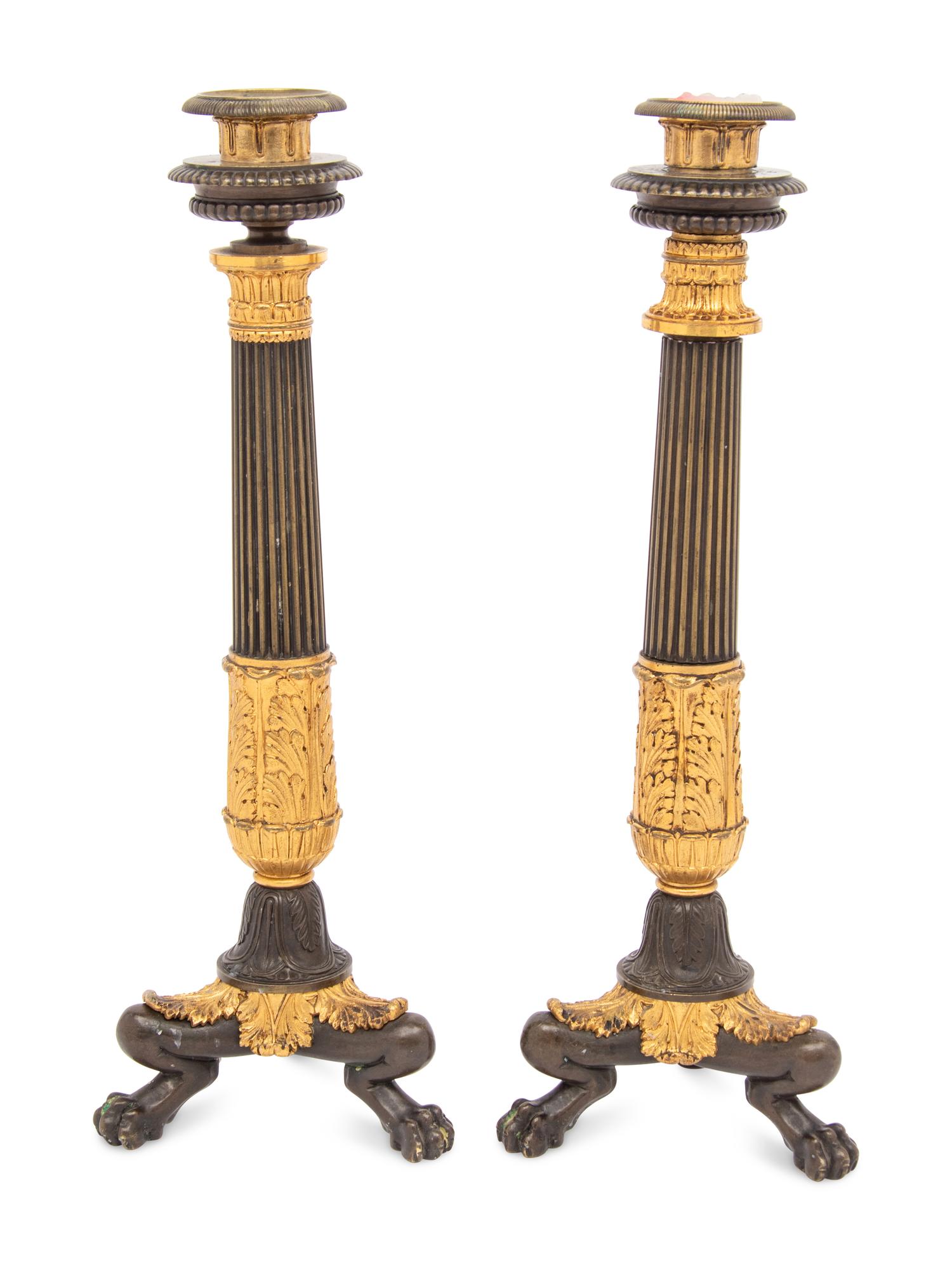 A Pair of French Parcel Gilt and Patinated Bronze Candlesticks