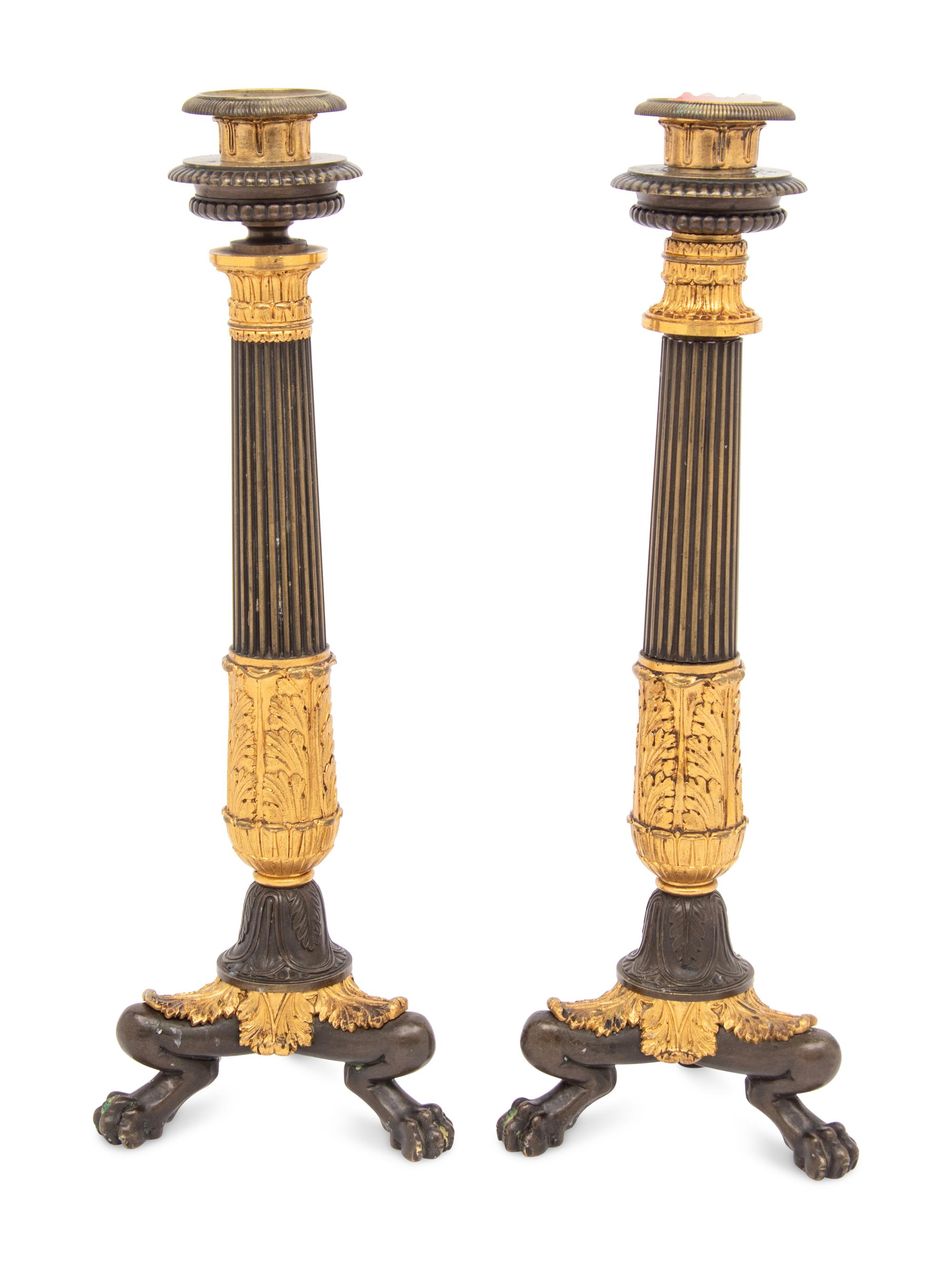 A Pair of French Parcel Gilt and Patinated Bronze Candlesticks