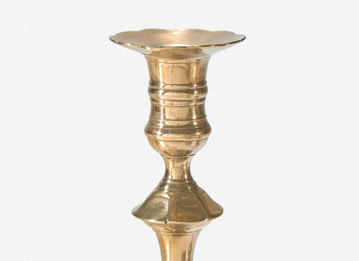 A group of ten George II scallop or petal-base brass candlesticks, England, 18th century