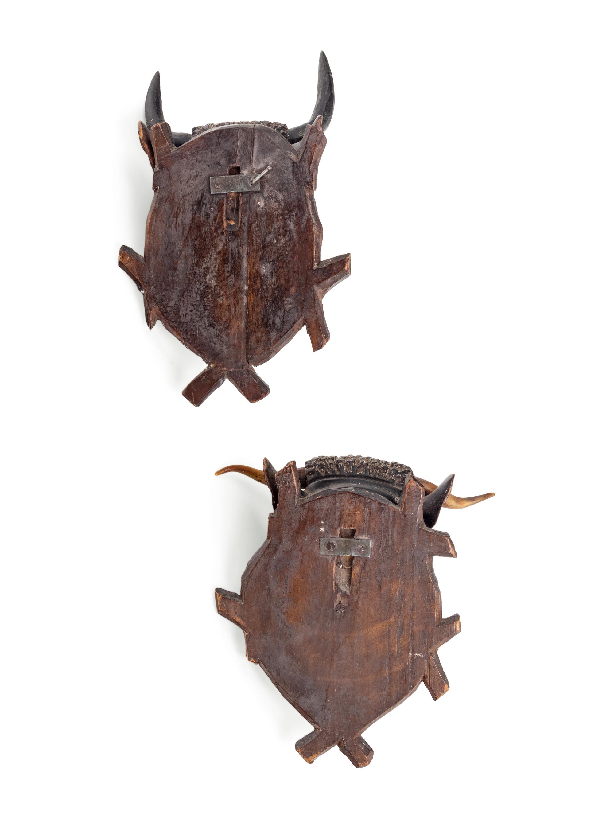 A Pair of Black Forest Carved Wood Bull Wall Mounts