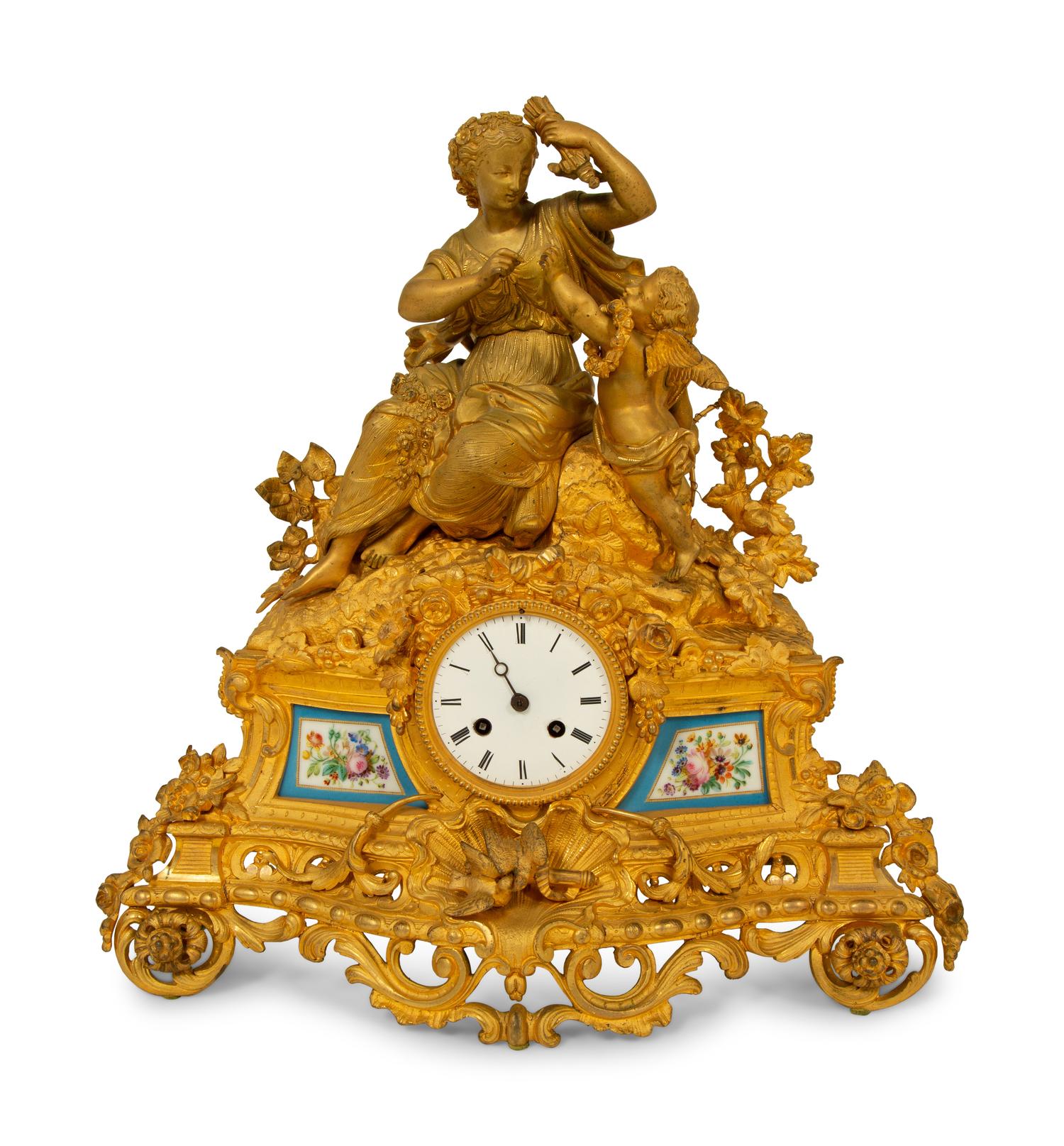 A Louis XV Style Gilt Bronze and Porcelain Inset Mantel Clock — 19TH CENTURY