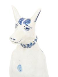 A Delft Blue and White Seated Dog and a Recumbent Cow