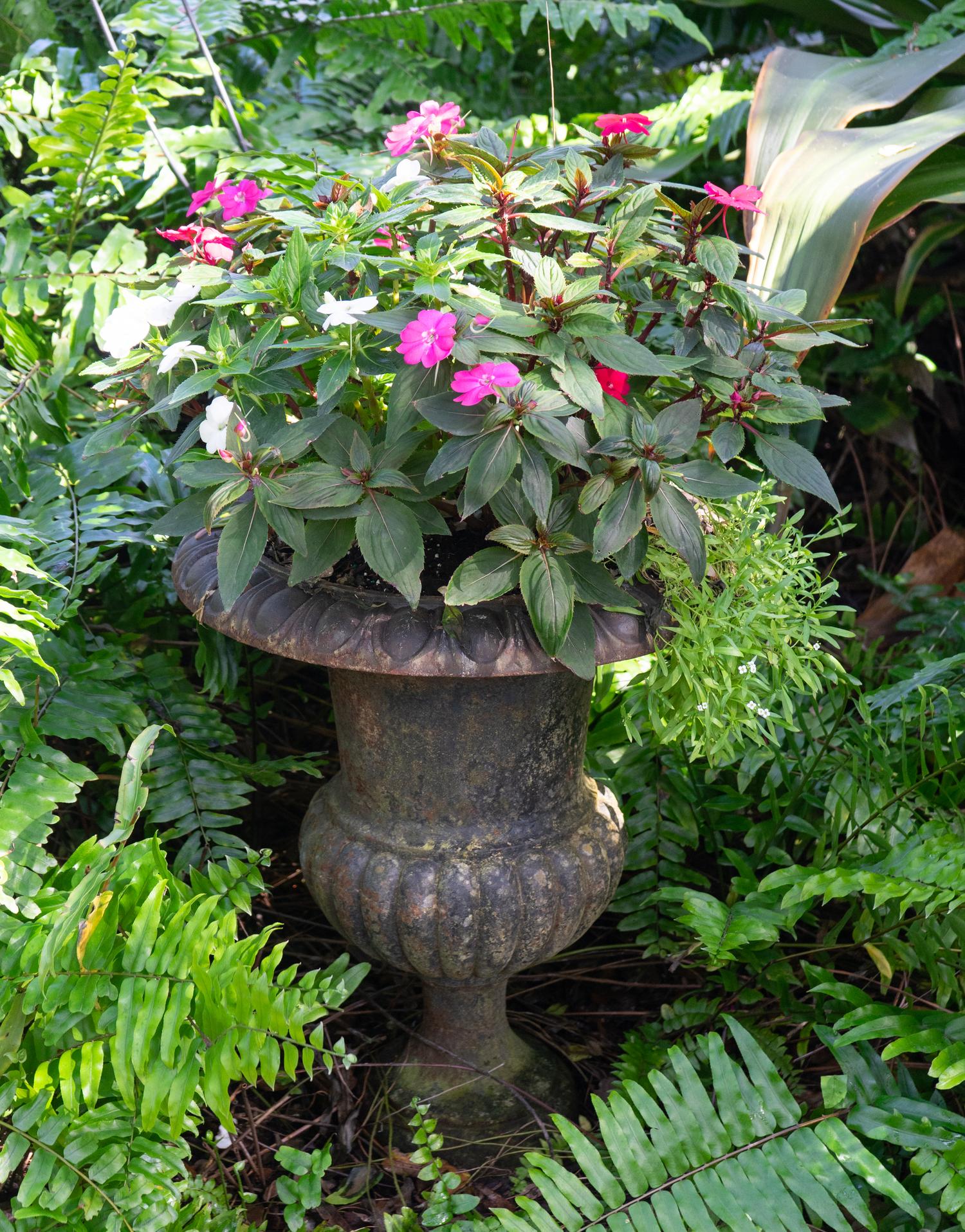 A Pair of Cast Iron Campana-form Garden Urns on Pedestals