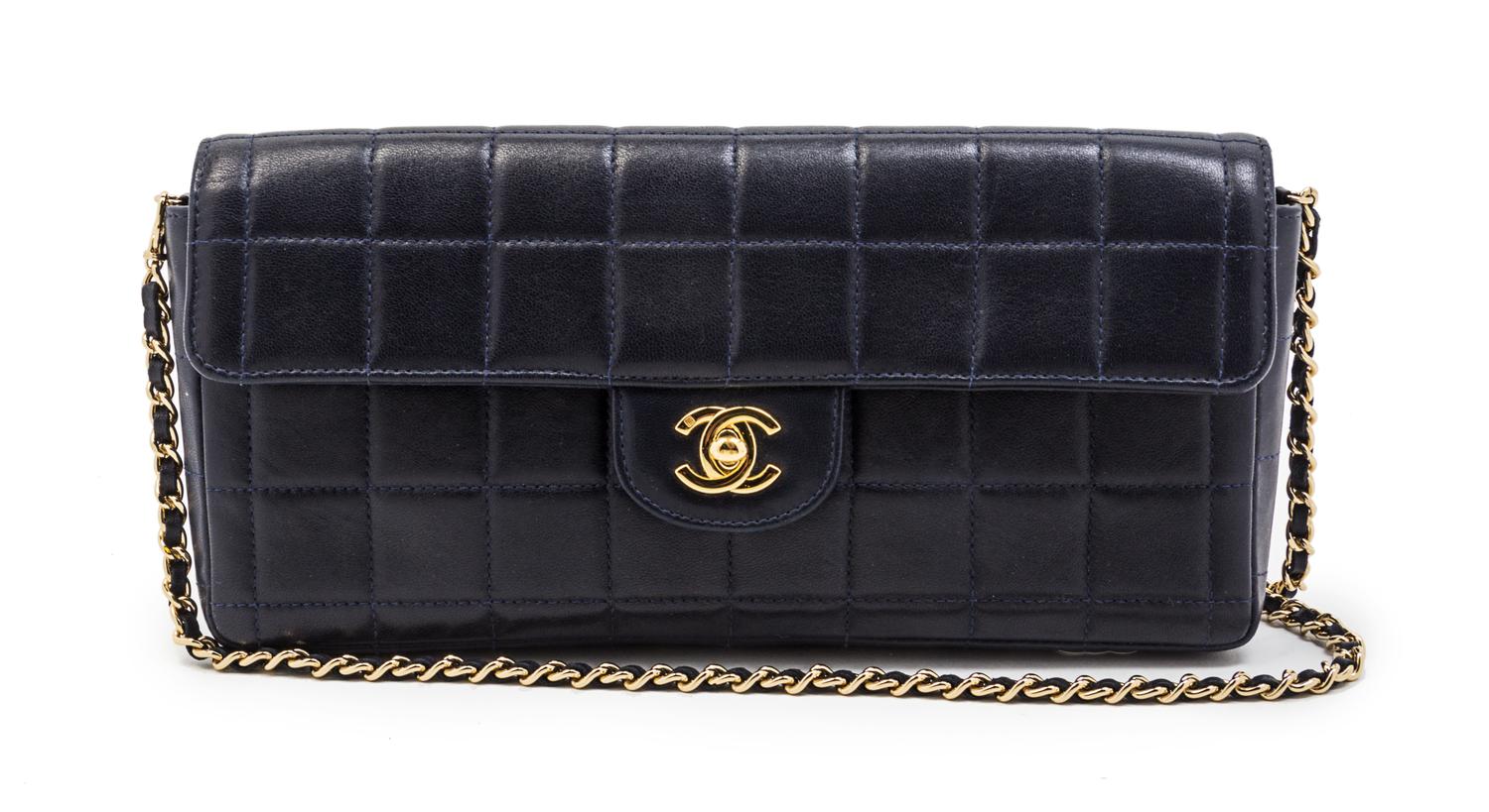 A Chanel Navy Quilted Leather Convertible Flap Bag, 10 1/2 x 5 x 1 1/2 inches.