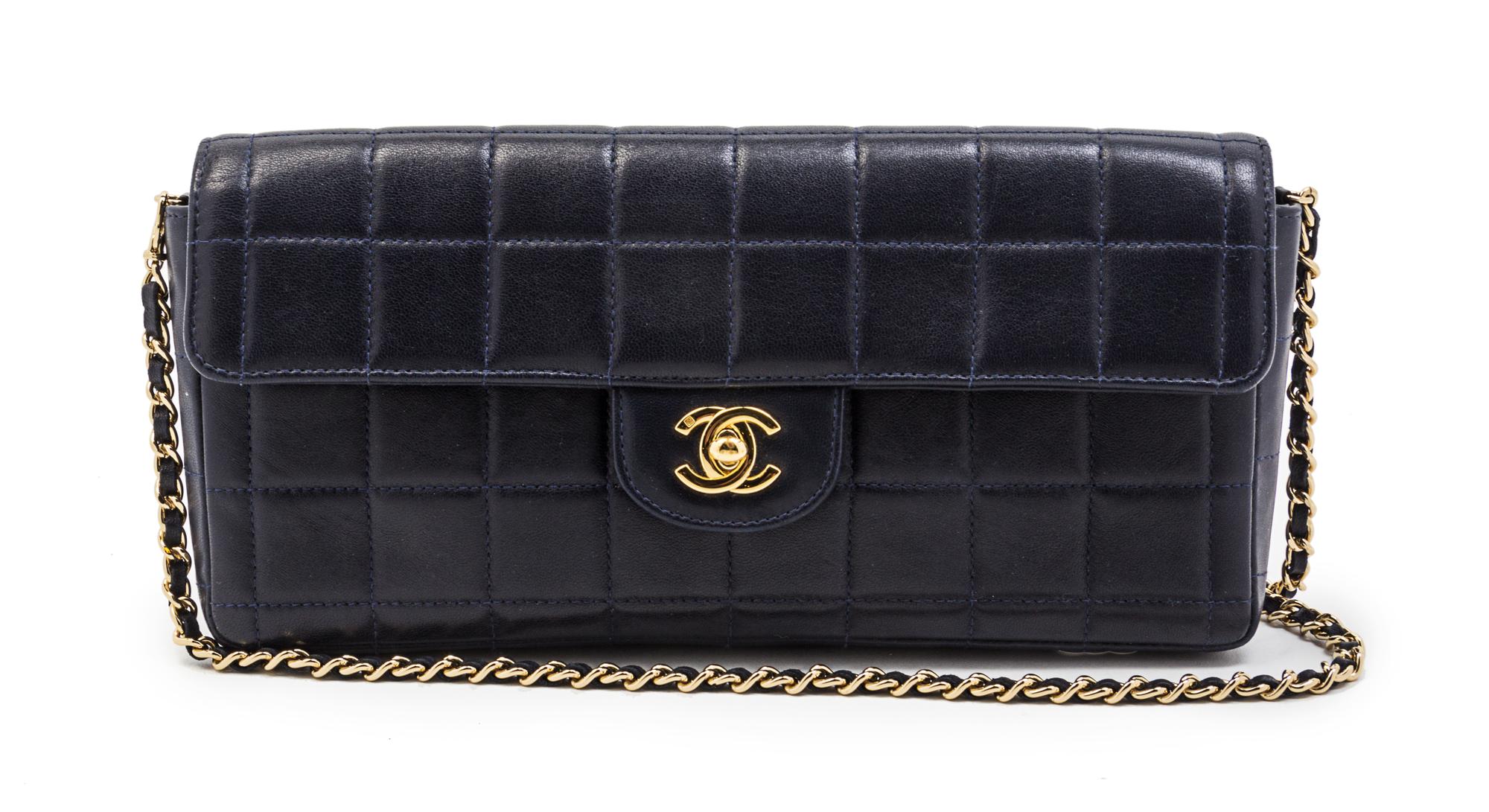A Chanel Navy Quilted Leather Convertible Flap Bag, 10 1/2 x 5 x 1 1/2 inches.
