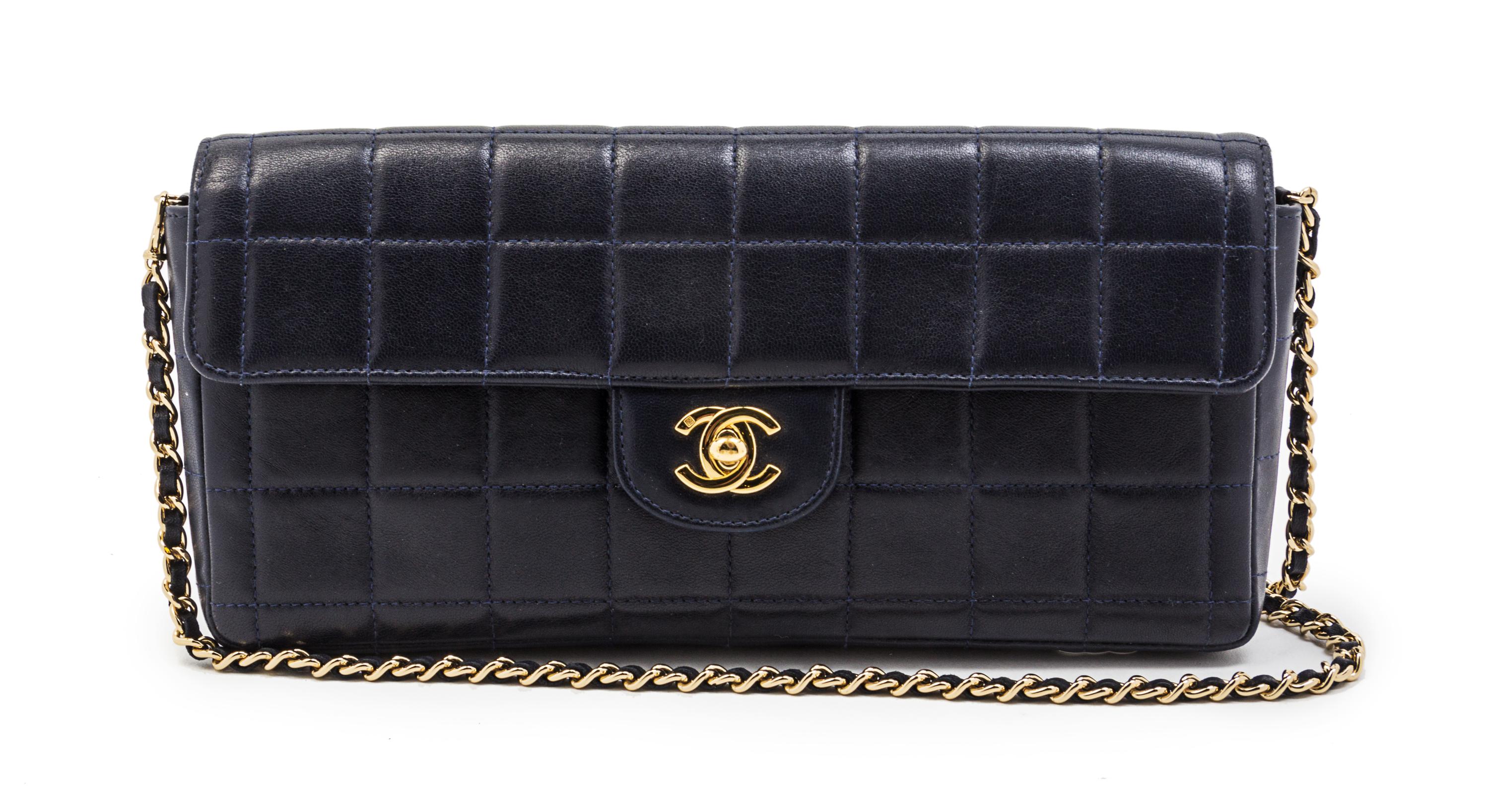 A Chanel Navy Quilted Leather Convertible Flap Bag, 10 1/2 x 5 x 1 1/2 inches.
