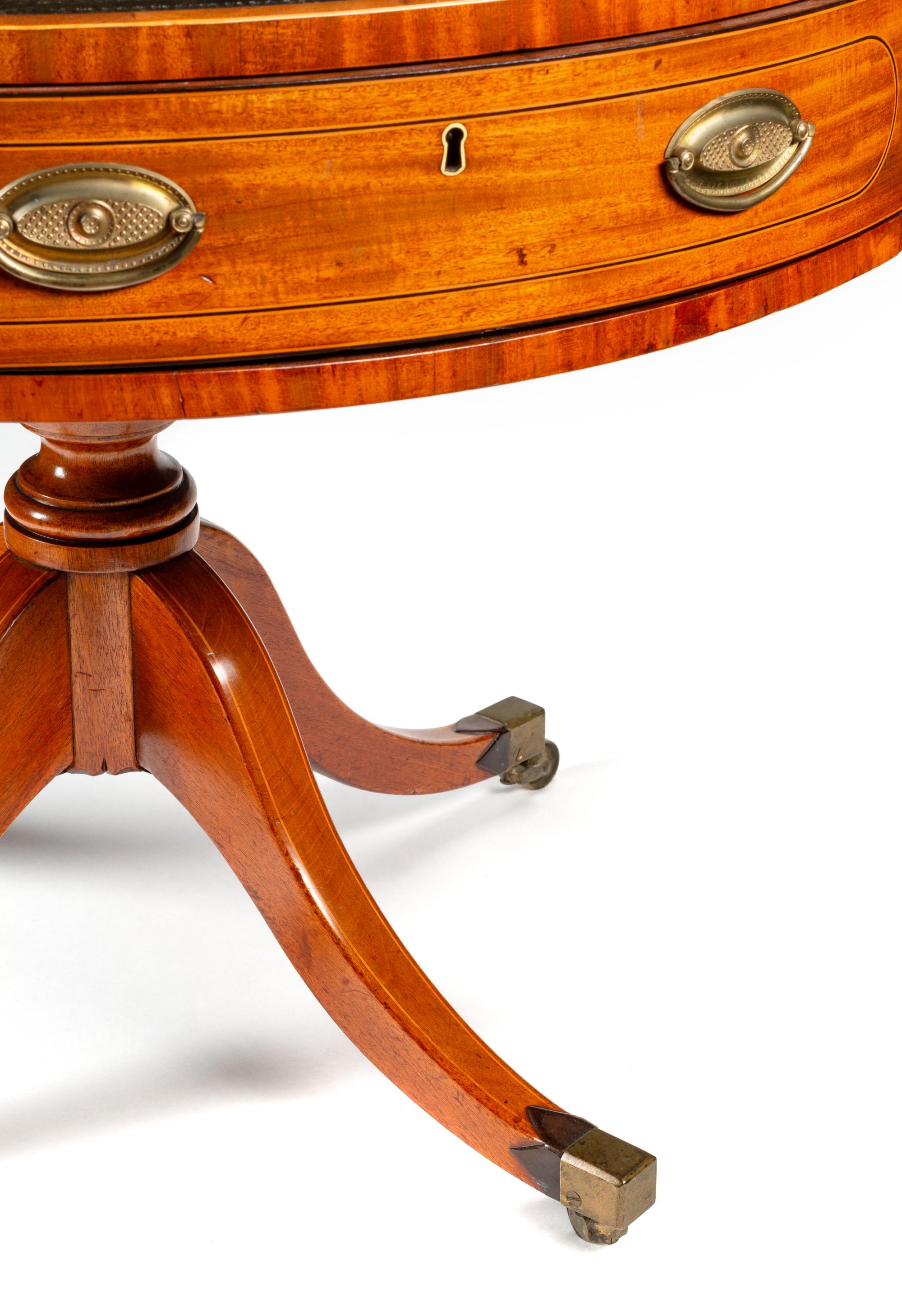 A Regency Mahogany and Satinwood Drum Table