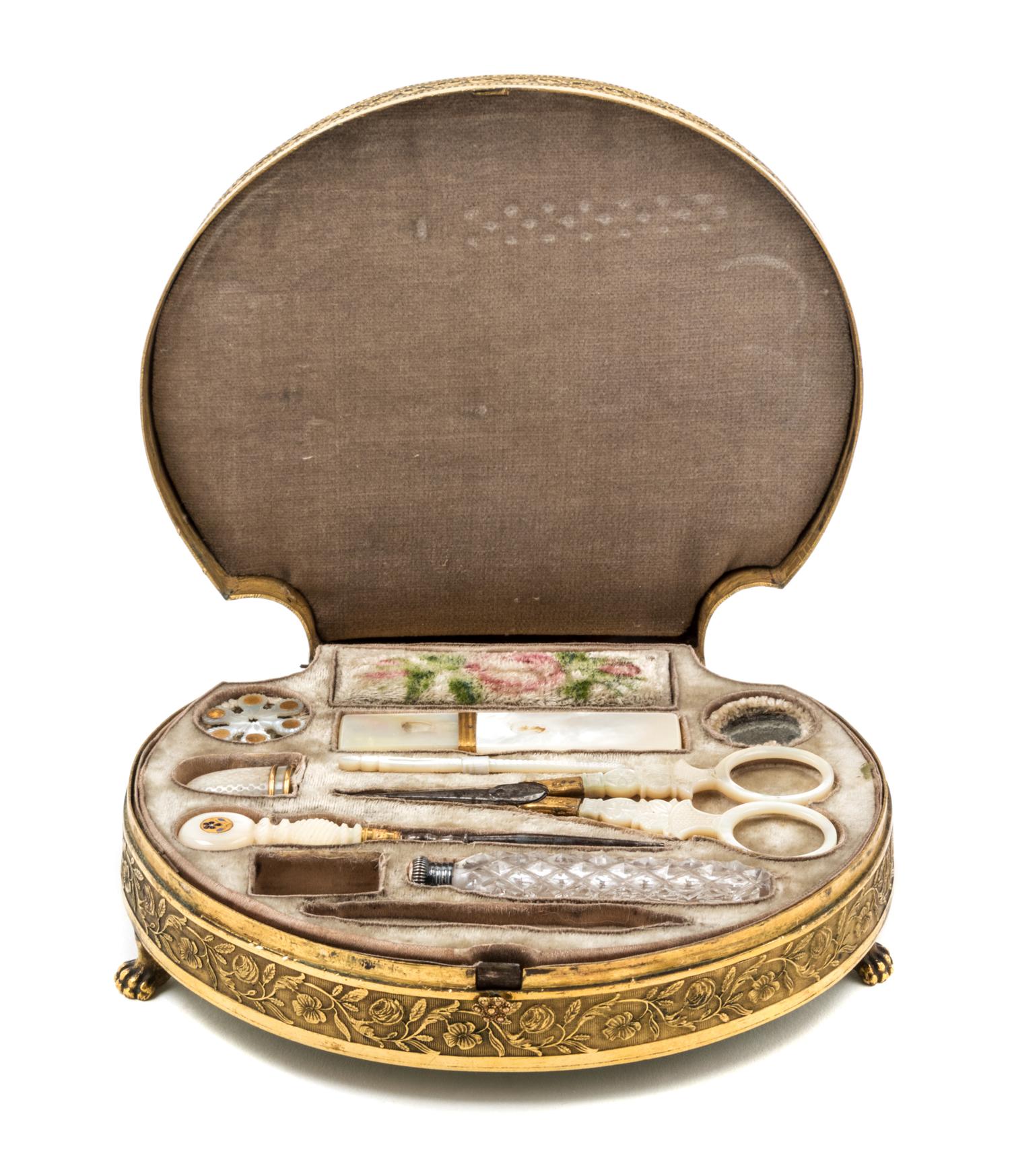 A Palais Royal Gilt Metal Mounted Tortoise Shell Sewing Kit, , the scallop form case having a tortoise shell inset lid with a gilt meta