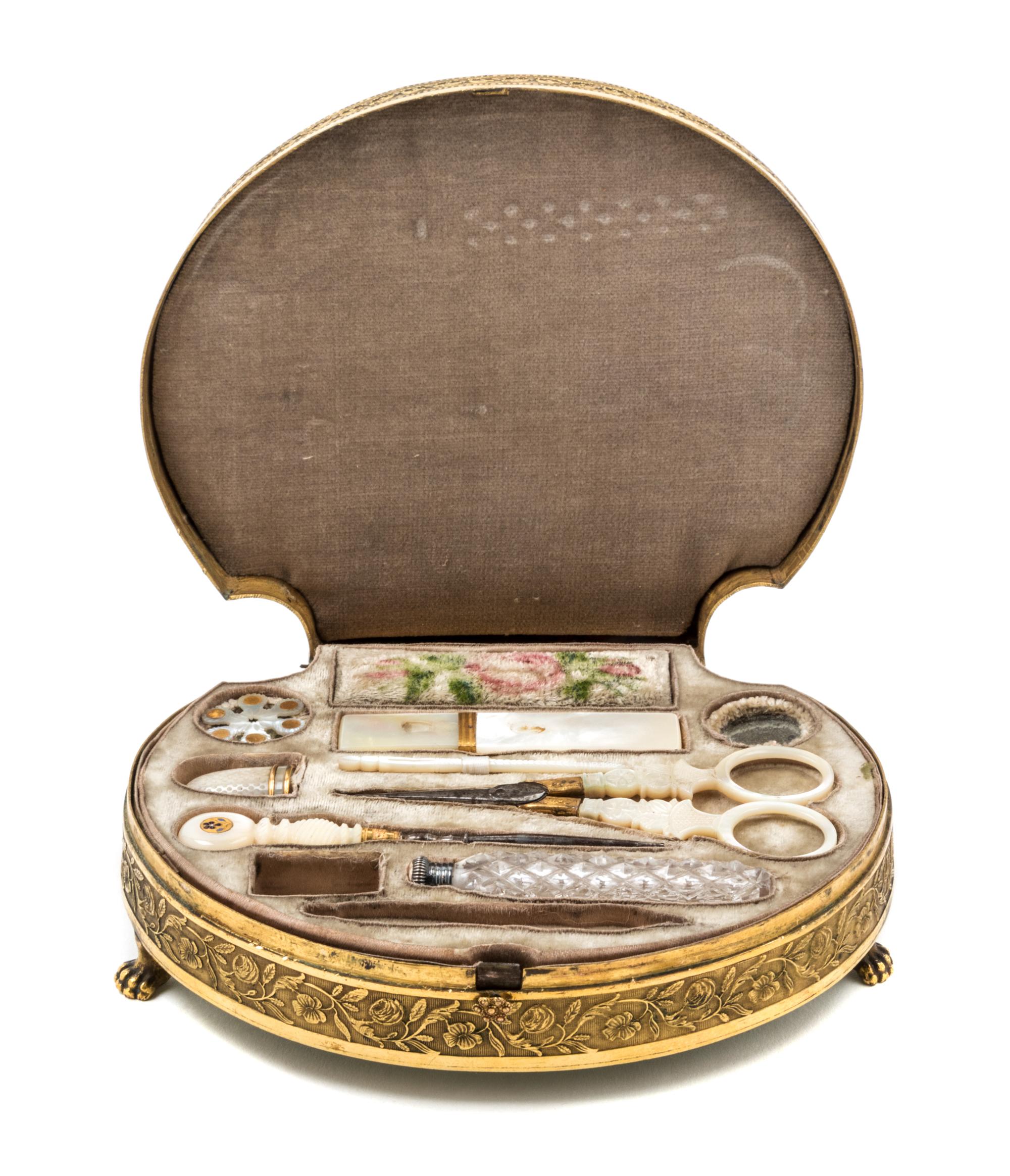 A Palais Royal Gilt Metal Mounted Tortoise Shell Sewing Kit, , the scallop form case having a tortoise shell inset lid with a gilt meta