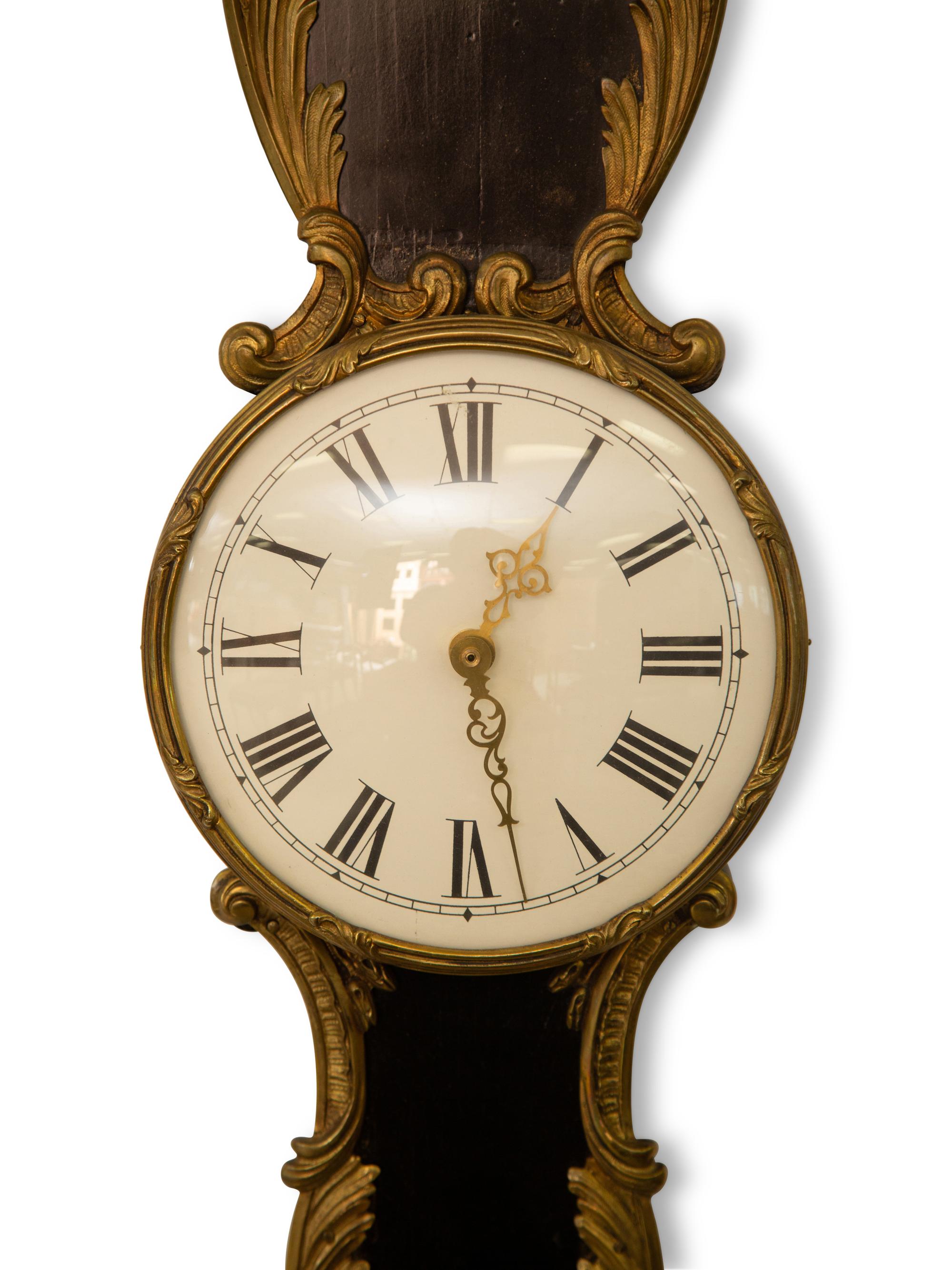 A French Empire Style Ebonized and Parcel Gilt Banjo Clock