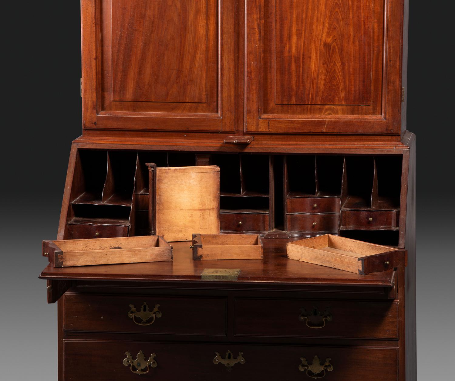 A Chippendale Figured Mahogany Bonnet Top Desk-and-Bookcase